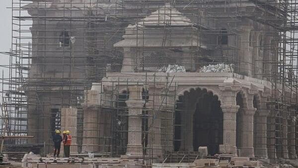 <div class="paragraphs"><p>Workers stand in front of the under construction site of the Hindu Ram Temple in Ayodhya, India, December 29, 2023.</p></div>