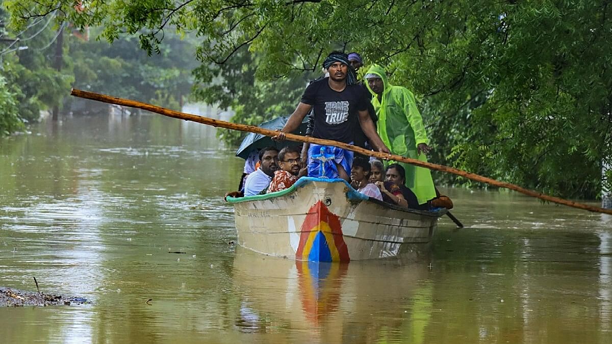 <div class="paragraphs"><p>People use a boat to shift from a flooded road following heavy rains in Tirunelveli, Tamil Nadu.&nbsp;</p></div>