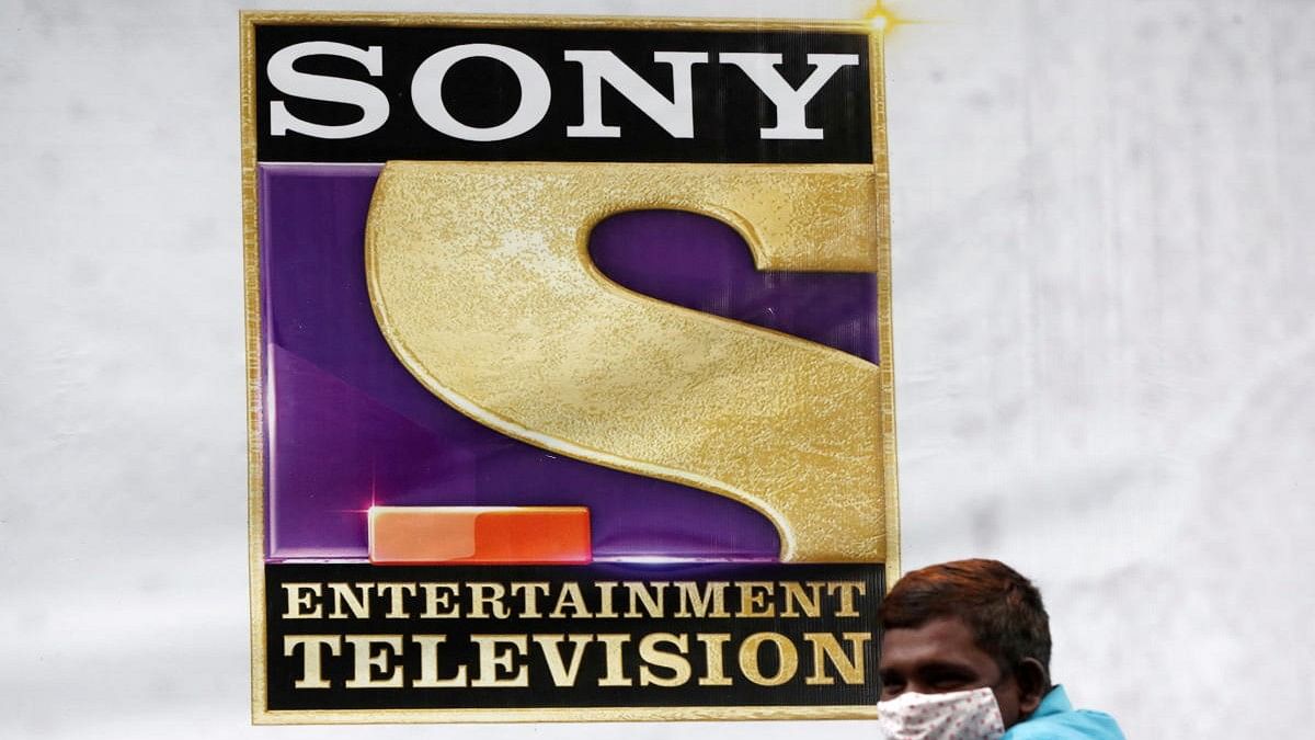 <div class="paragraphs"><p>A man stands next to a banner of Sony Entertainment, outside a film set in Mumbai.</p></div>