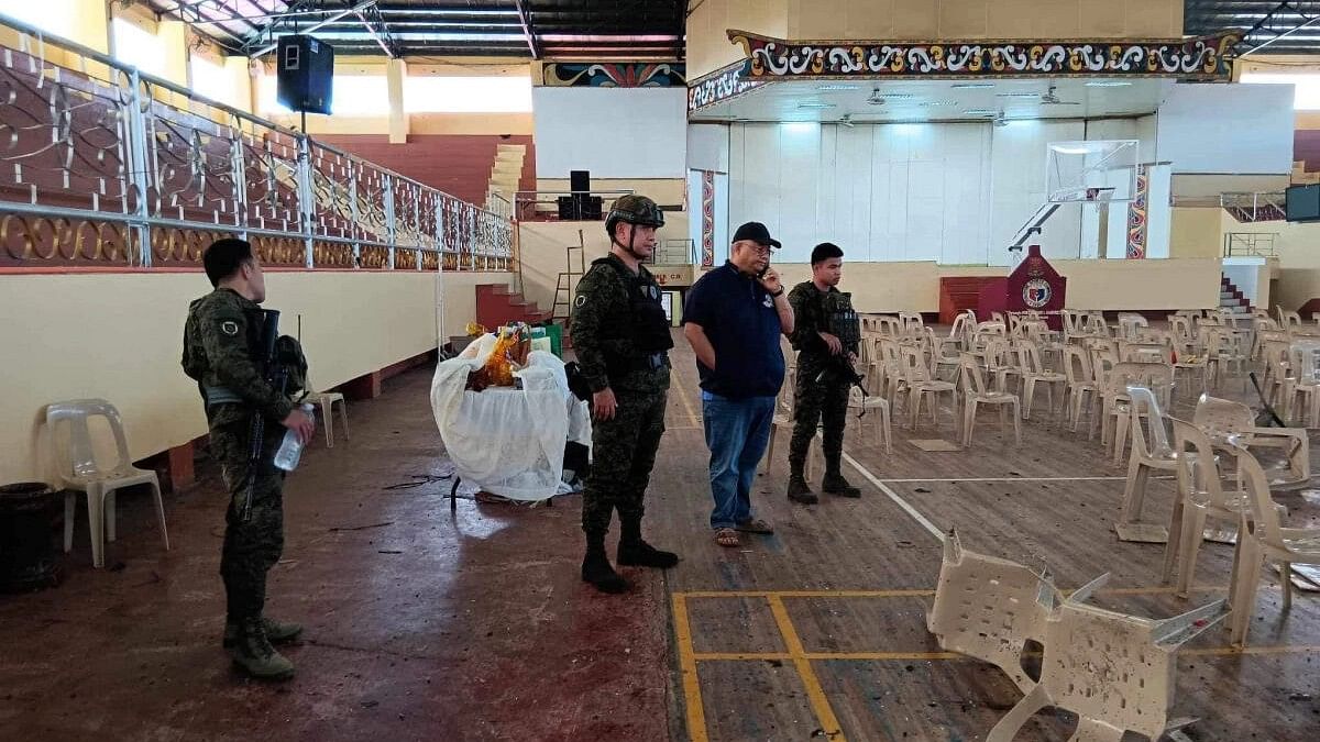 <div class="paragraphs"><p>Law enforcement officers investigate the scene of an explosion that occurred during a Catholic Mass in a gymnasium at Mindanao State University in Marawi, Philippines.</p></div>