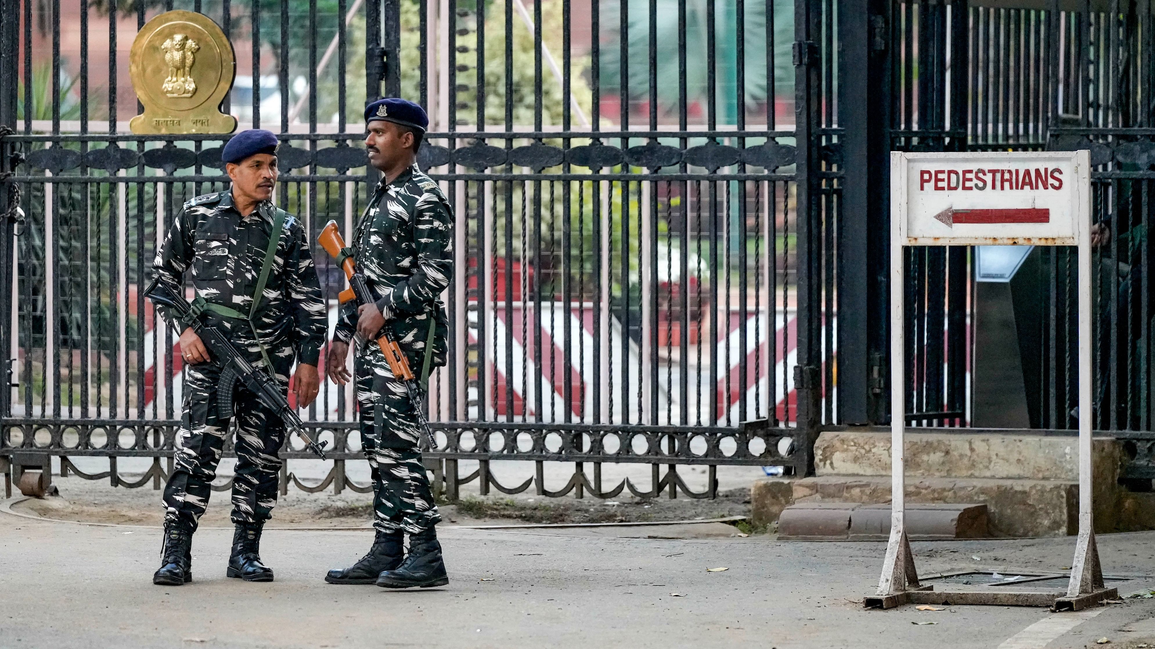 <div class="paragraphs"><p>Security personnel stand guard outside the Parliament House complex during the Winter session, in New Delhi.&nbsp;</p></div>