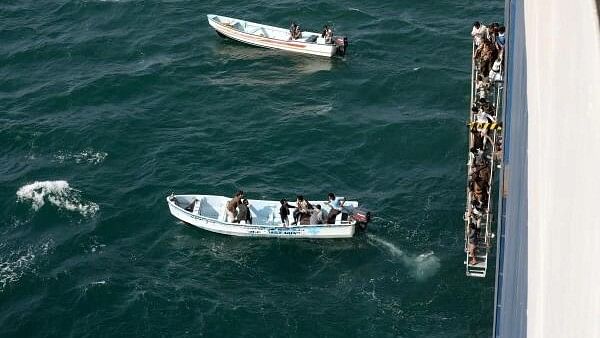 <div class="paragraphs"><p>People walk down a ladder after they toured the Galaxy Leader commercial ship, seized by Yemen's Houthis last month, off the coast of al-Salif, Yemen December 5, 2023.</p></div>