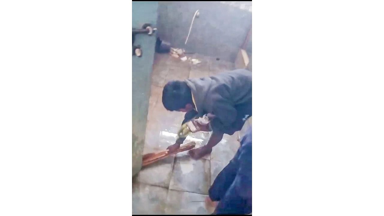 <div class="paragraphs"><p>A video grab of a boy cleaning the toilet in a government school.&nbsp;</p></div>