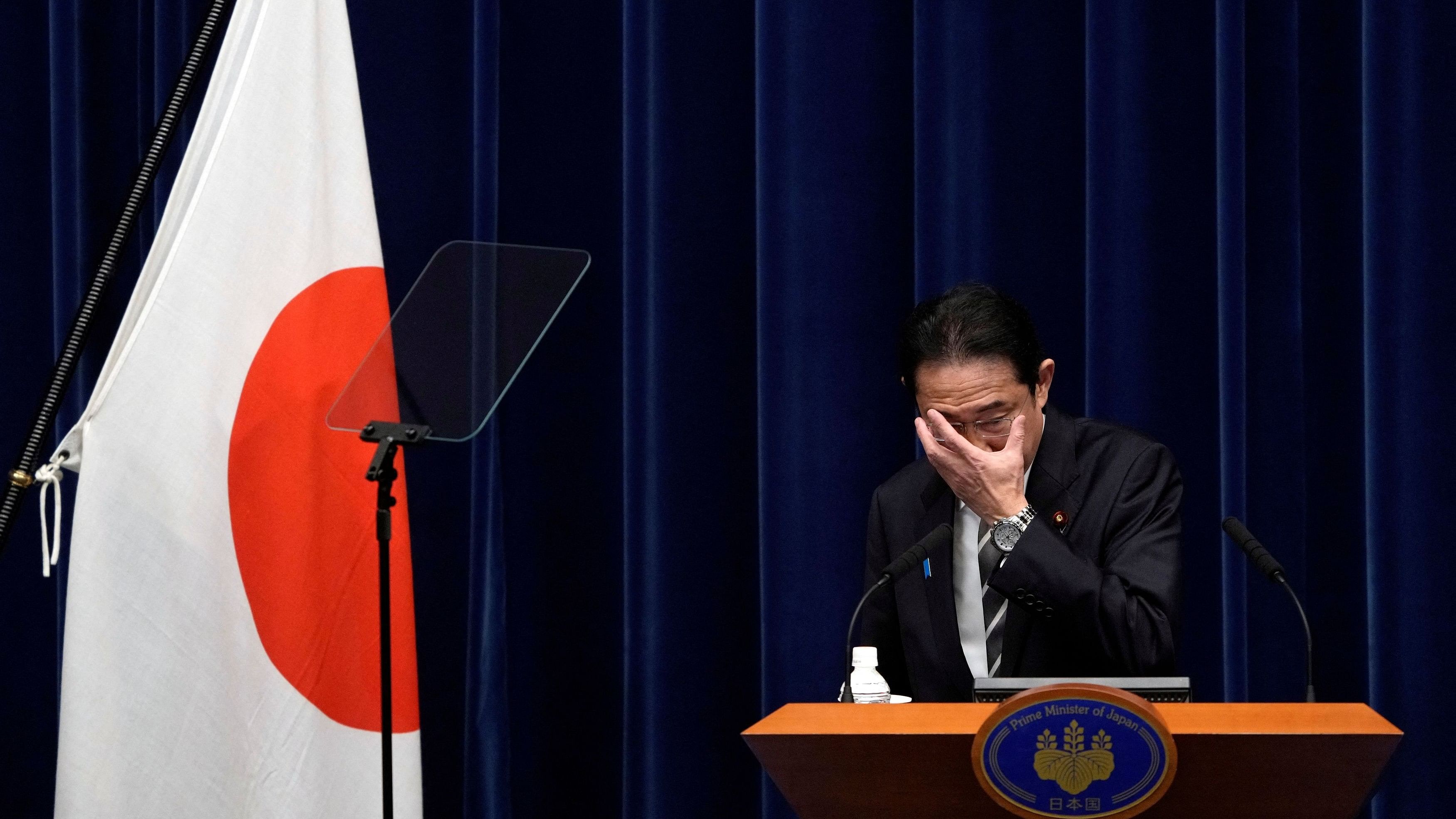 <div class="paragraphs"><p>Japanese Prime Minister Fumio Kishida adjusts his glasses during a news conference at the prime minister's office in Tokyo.</p></div>