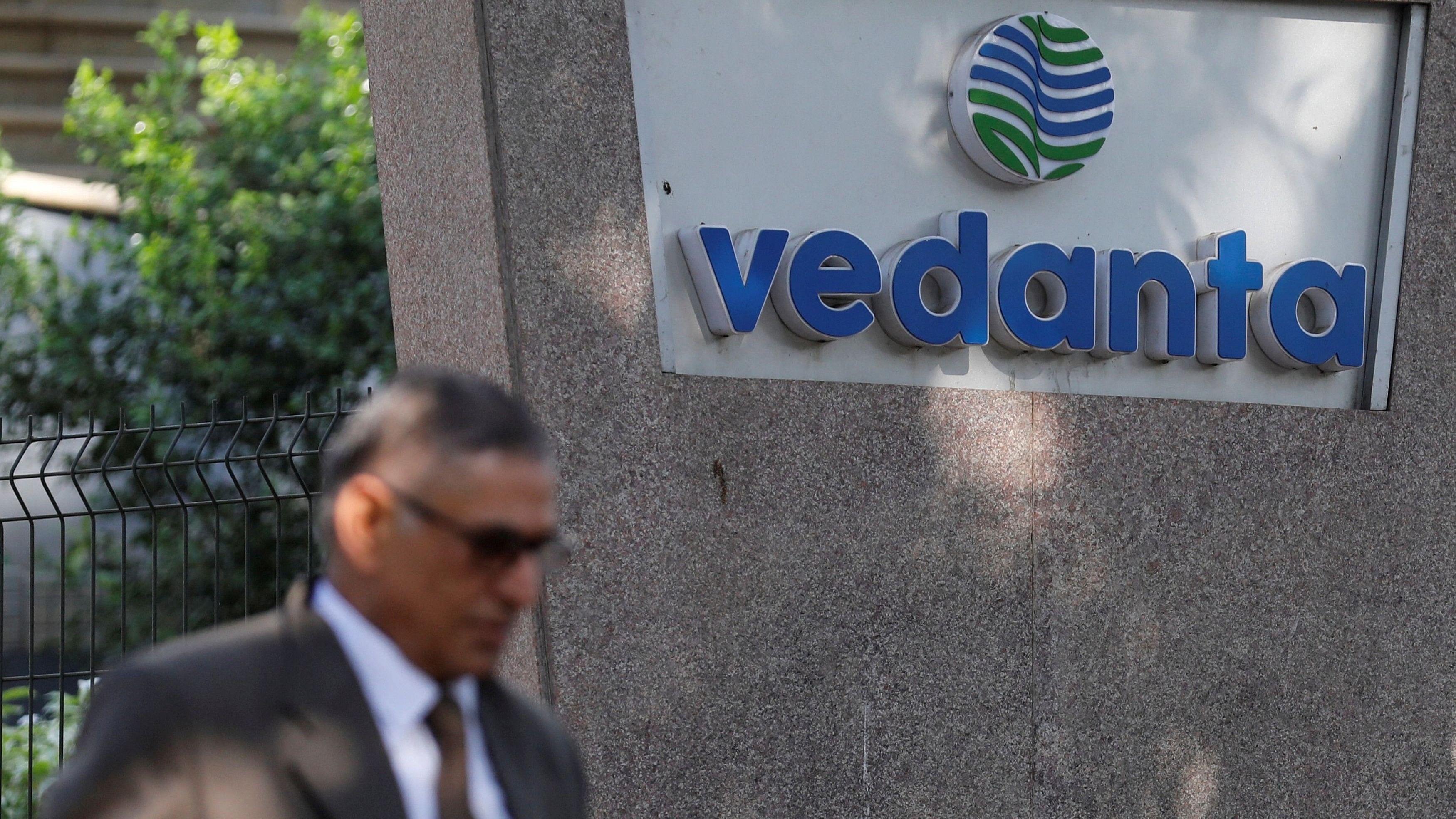 <div class="paragraphs"><p>A man walks past the logo of Vedanta outside its headquarters in Mumbai, India.</p></div>
