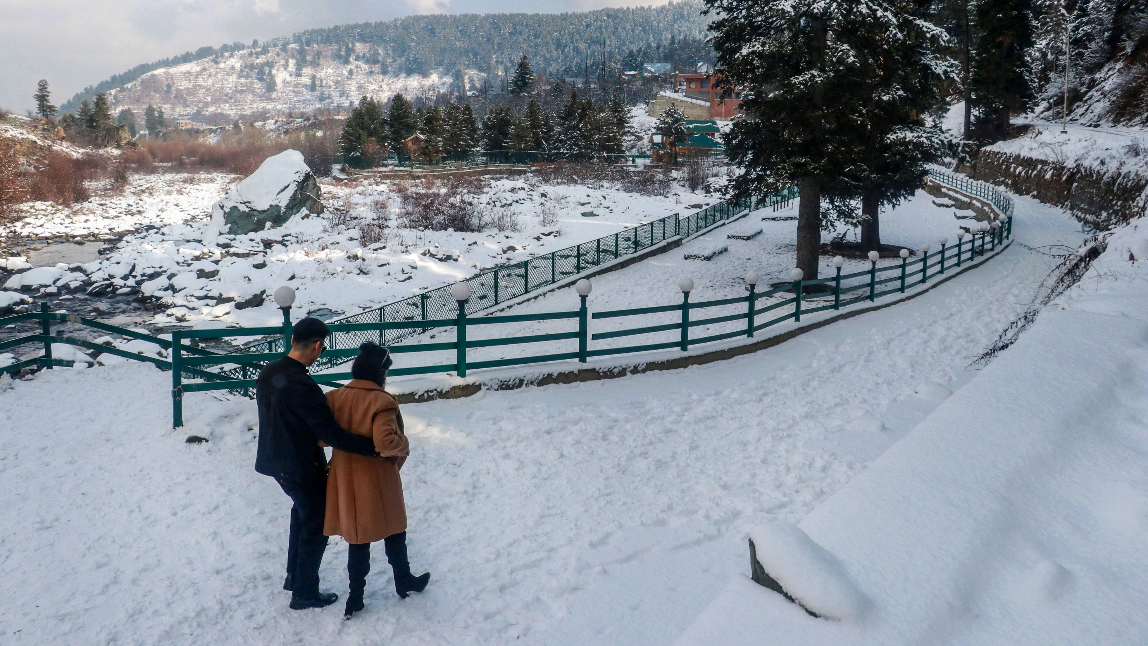 <div class="paragraphs"><p>Tangmarg: Tourists walk on a snow-covered road after a fresh snowfall, in Tangmarg, Jammu and Kashmir, Sunday, Dec. 17, 2023. </p></div>