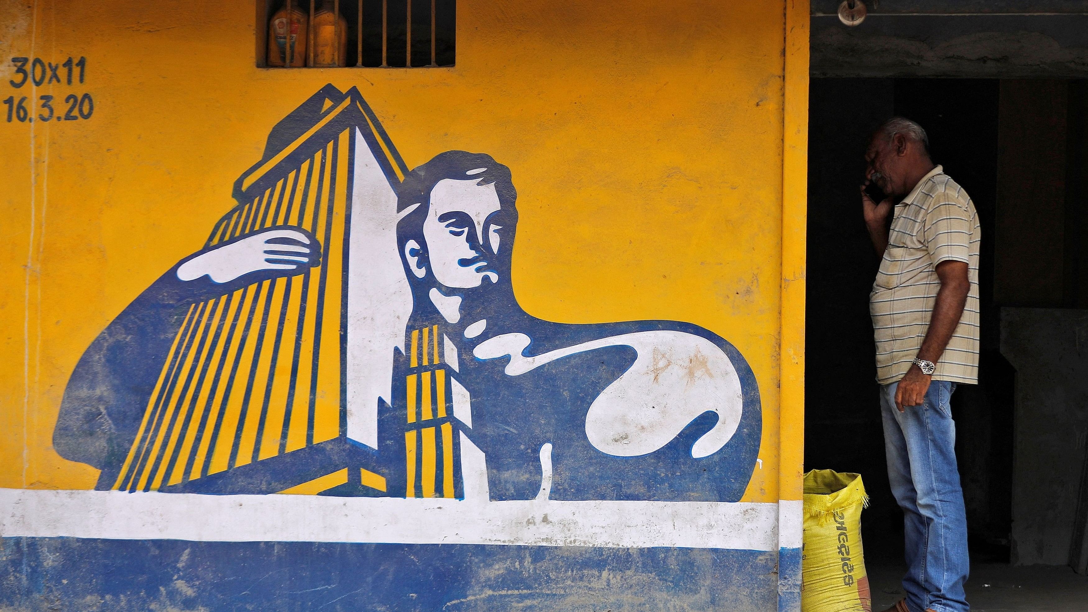 <div class="paragraphs"><p> A dealer selling Ambuja cement speaks on his phone at his shop in Ahmedabad.</p></div>