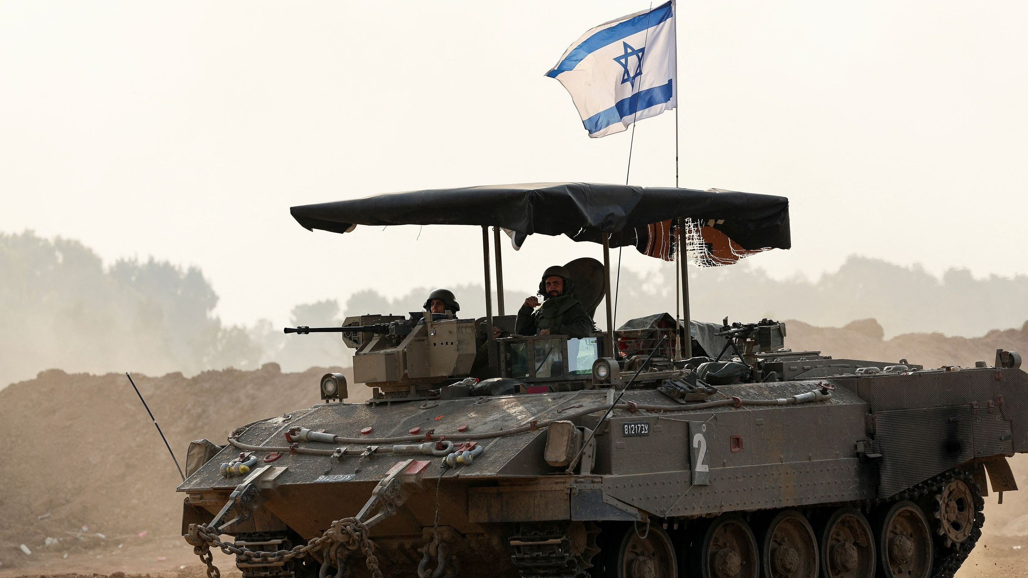 <div class="paragraphs"><p>Israeli soldiers ride a military vehicle, amid the ongoing conflict between Israel and the Palestinian Islamist group Hamas, near the Israel-Gaza border, in southern Israel, December 28, 2023. </p></div>