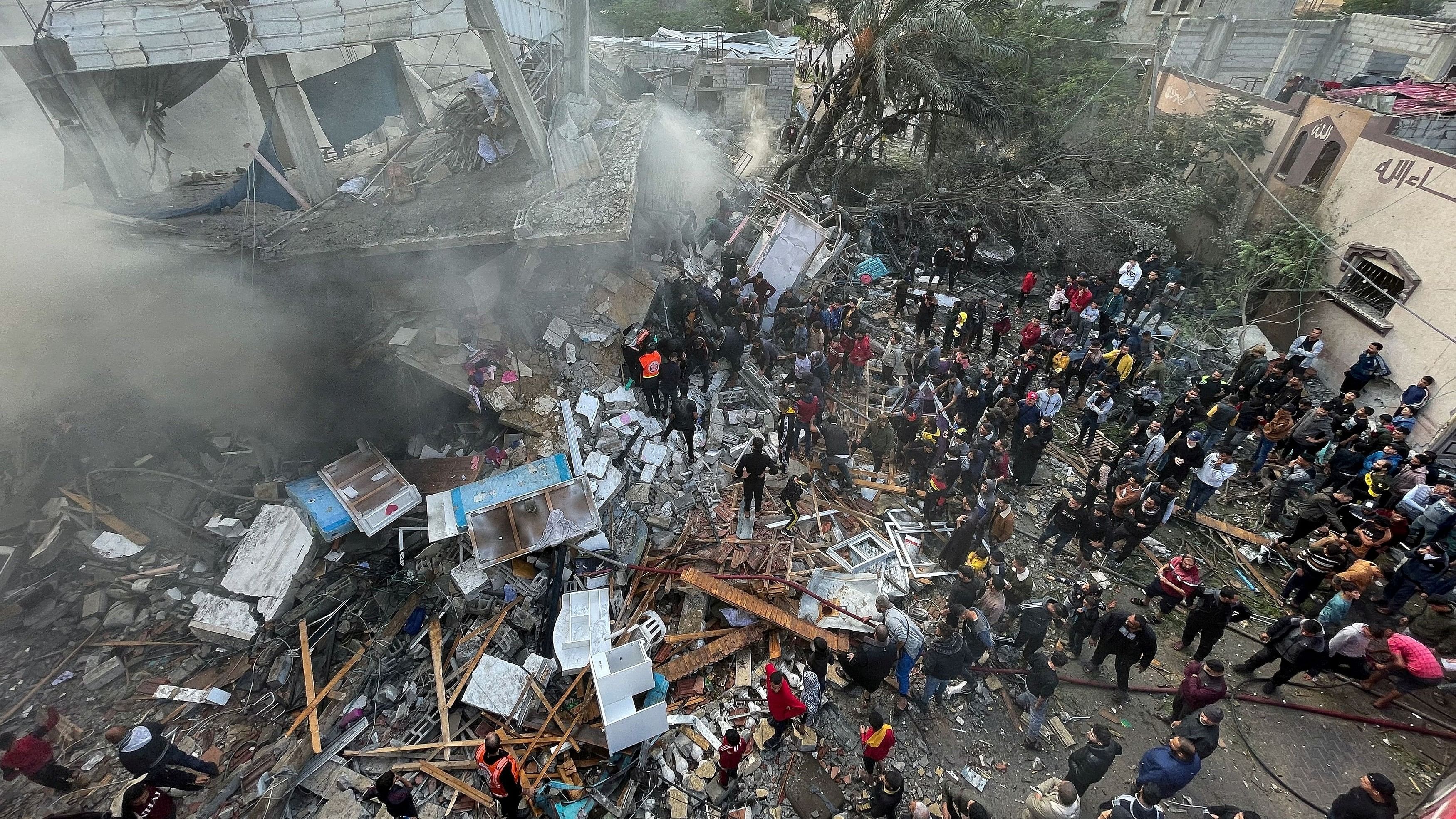 <div class="paragraphs"><p>Palestinians inspect the site of an Israeli strike on a house, amid the ongoing conflict between Israel and Palestinian Islamist group Hamas, in Rafah in the southern Gaza Strip.</p></div>