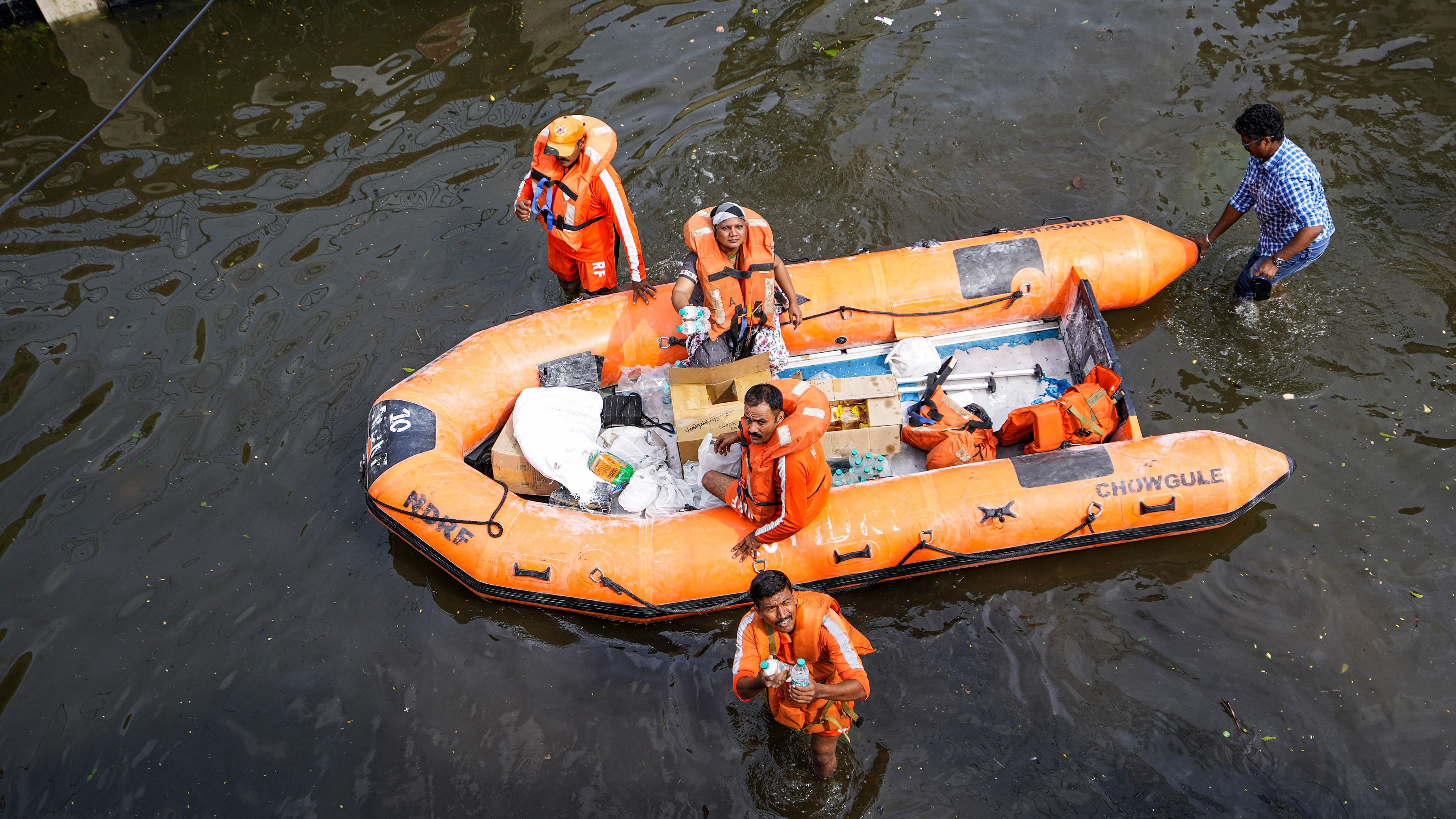 <div class="paragraphs"><p>NDRF personnel distribute food and other items amid floods after heavy rainfall in the aftermath of Cyclone Michaung, in Chennai, Thursday, Dec. 7, 2023.</p></div>