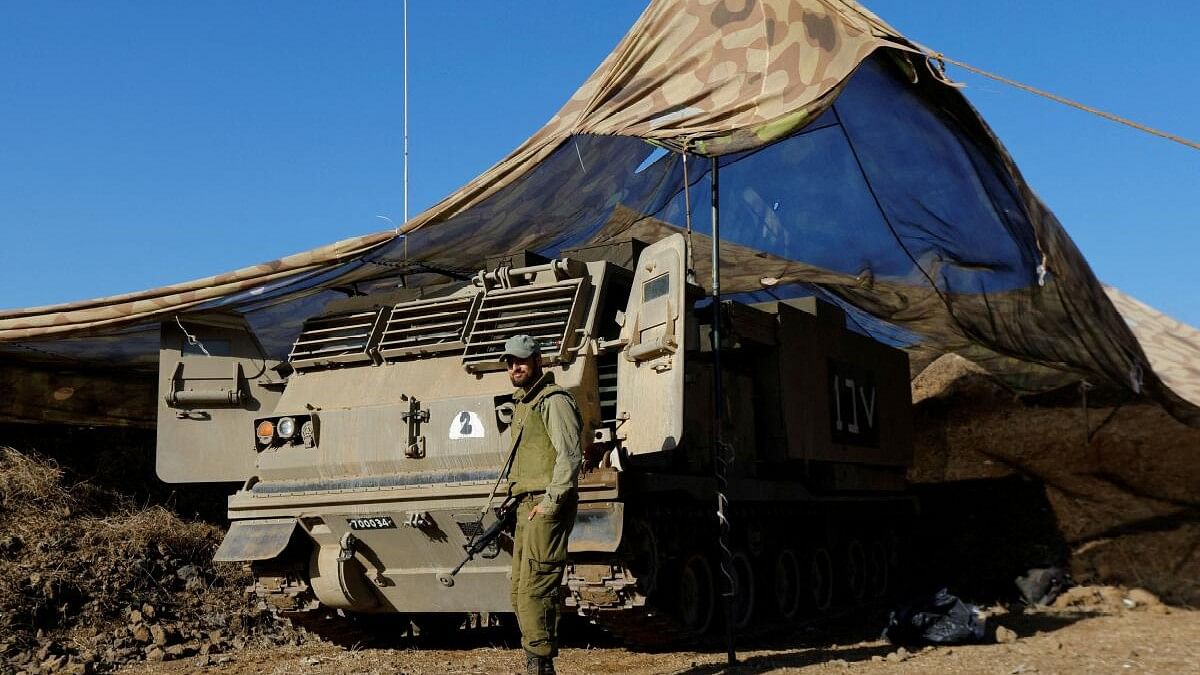 <div class="paragraphs"><p>An Israeli soldier stands near a rocket launcher in the Israeli-occupied Golan Heights.</p></div>