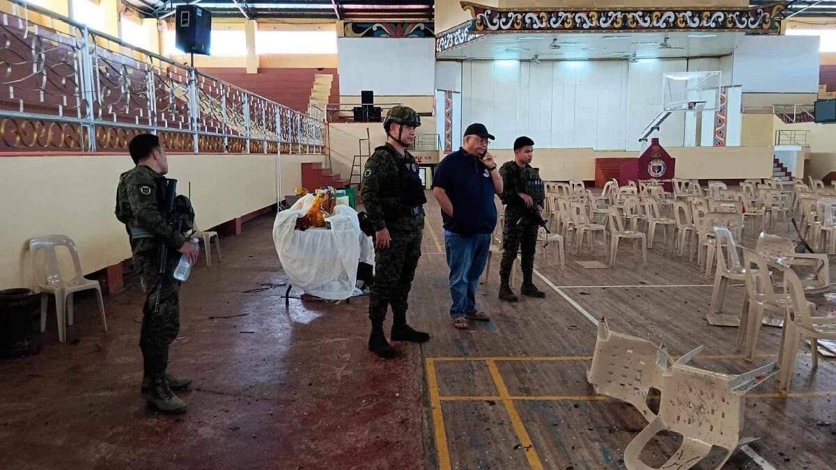 <div class="paragraphs"><p>Lanao Del Sur Governor Mamintal Adiong Jr. looks on as law enforcement officers investigate the scene of an explosion that occurred during a Catholic Mass in a gymnasium at Mindanao State University in Marawi, Philippines.</p></div>