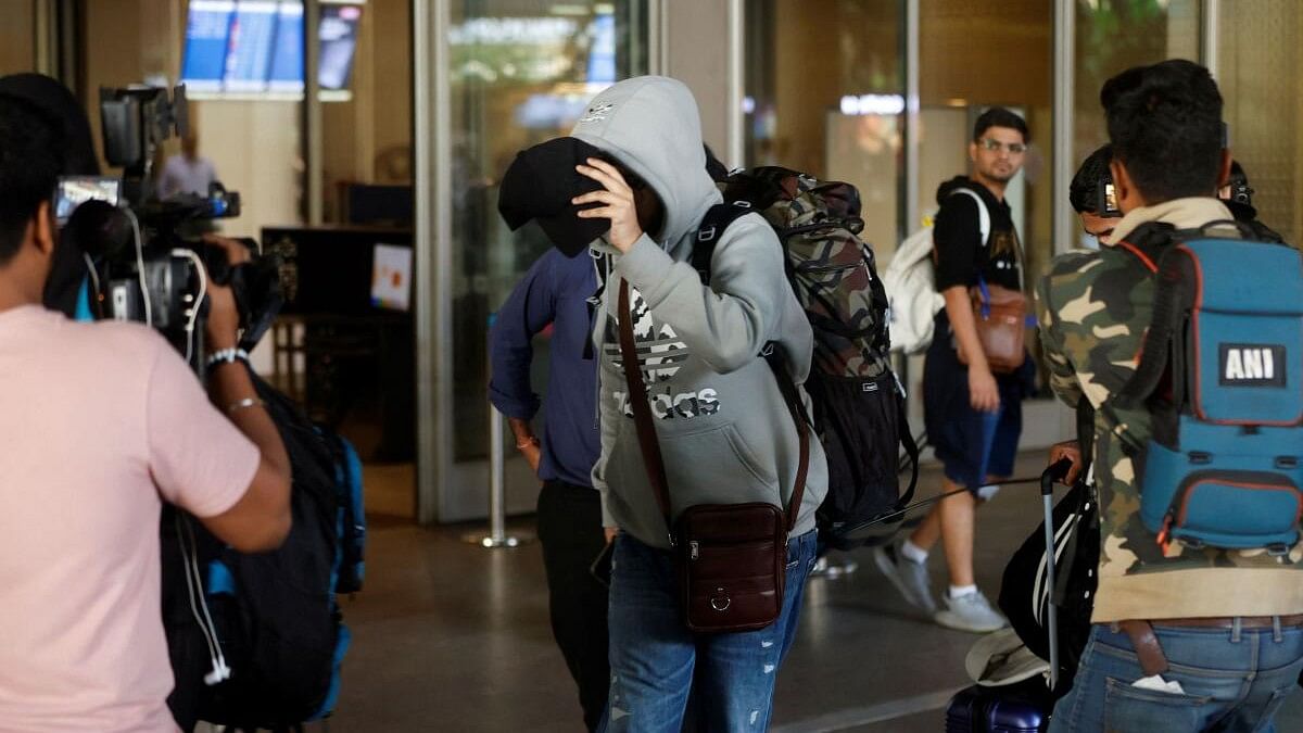 <div class="paragraphs"><p>A passenger from Nicaragua bound Airbus A340 flight that was grounded in France on suspicion of human trafficking, evades the media as he leaves the Chhatrapati Shivaji Maharaj International Airport after his arrival, in Mumbai, India, December 26, 2023.</p></div>