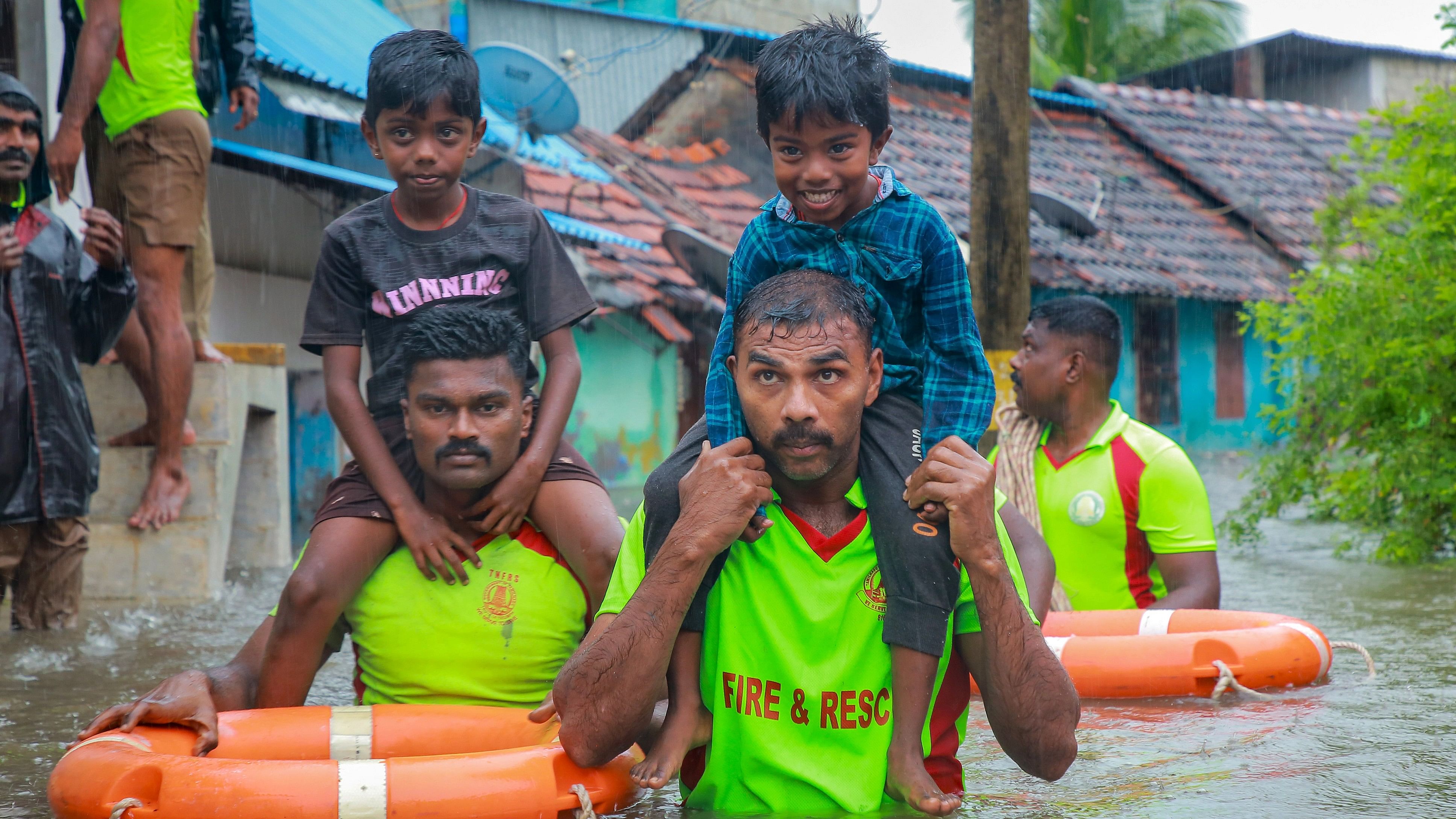 <div class="paragraphs"><p>Tamil Nadu Fire and Rescue Services personnel rescue children from a flooded area after heavy rain, in Kanyakumari district.</p></div>