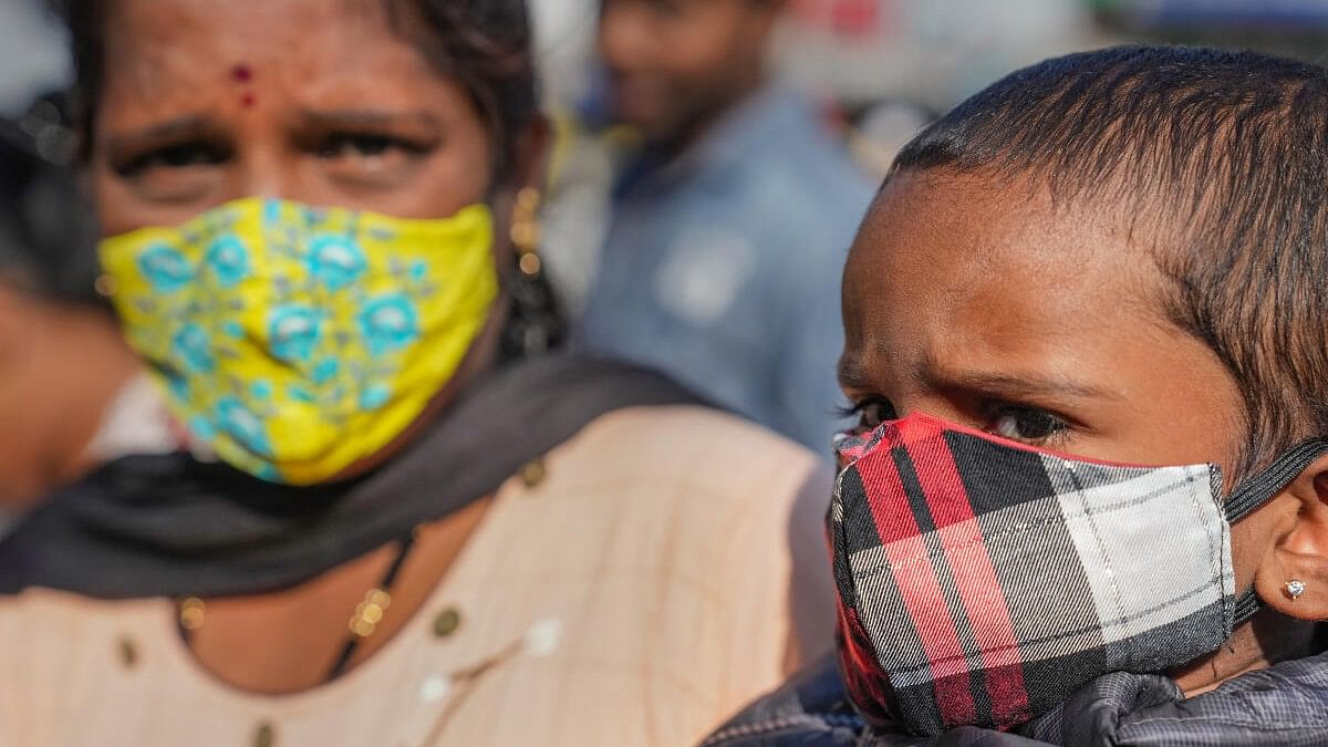 <div class="paragraphs"><p>People wear face masks for prevention against COVID-19 at a market in Bengaluru.</p></div>