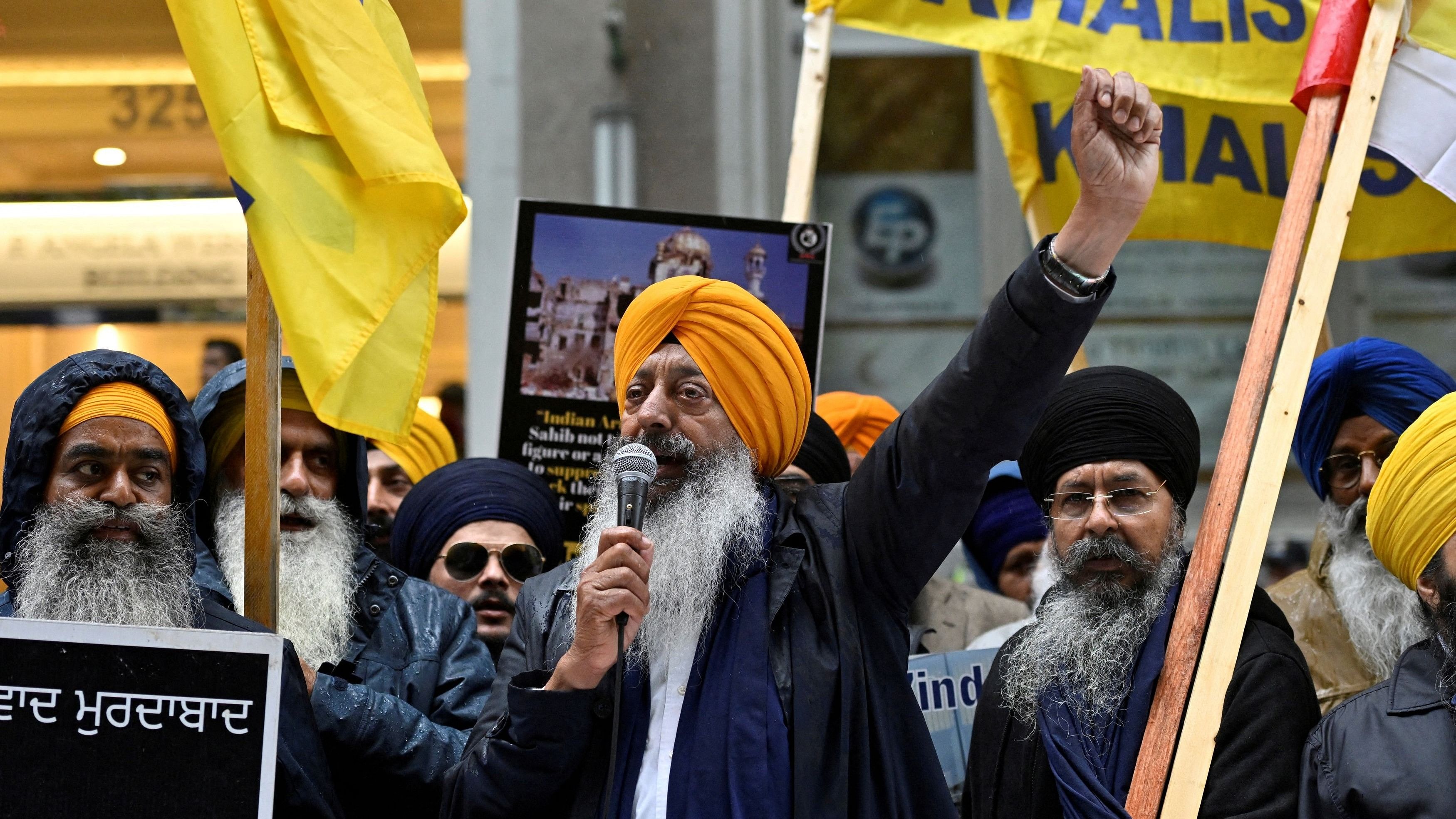 <div class="paragraphs"><p>A demonstrator uses a microphone as others hold flags and signs as they protest outside India's consulate, a week after Canada's Prime Minister Justin Trudeau raised the prospect of New Delhi's involvement in the murder of Sikh separatist leader Hardeep Singh Nijjar, in Vancouver, British Columbia, Canada </p></div>