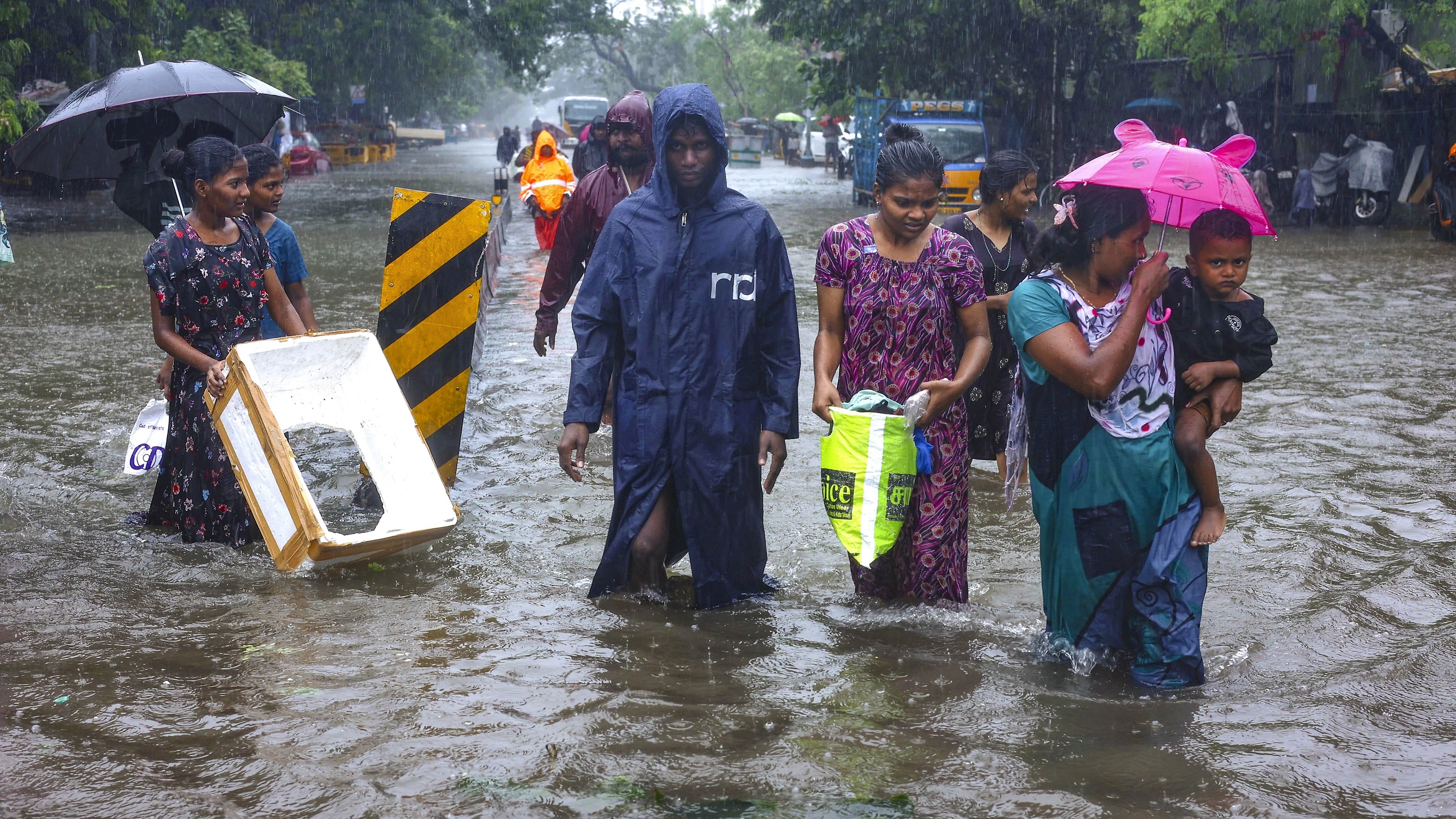 <div class="paragraphs"><p>People wade through a waterlogged road during heavy rain owing to Cyclone Michaung, in Chennai, Monday, Dec. 4, 2023. </p></div>