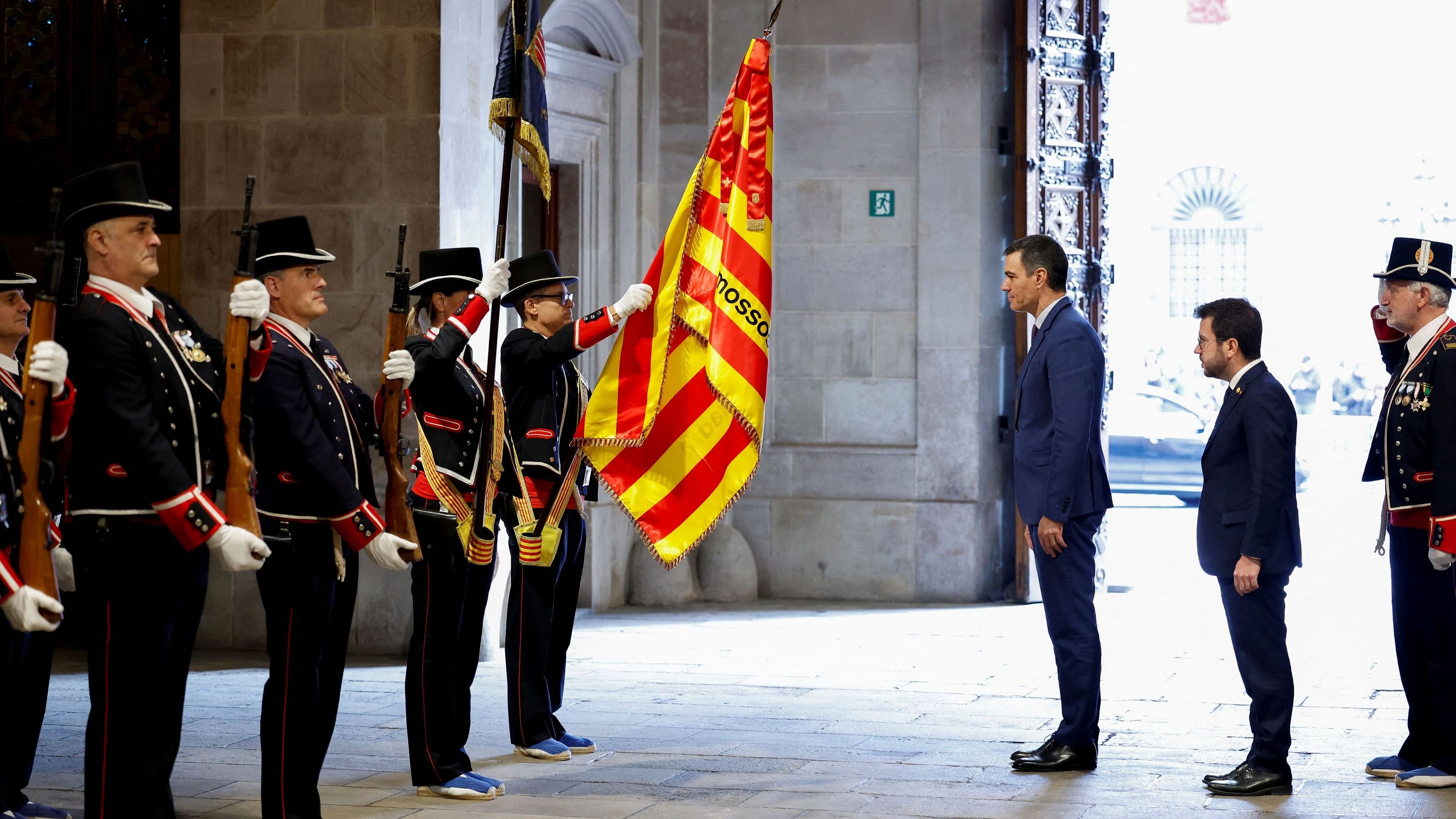 <div class="paragraphs"><p>Spain's Prime Minister Pedro Sanchez and Catalonia's President Pere Aragones stand in front of Mossos d'Esquadra police officers as they meet at Palau de la Generalitat in Barcelona, Spain December 21, 2023.</p></div>