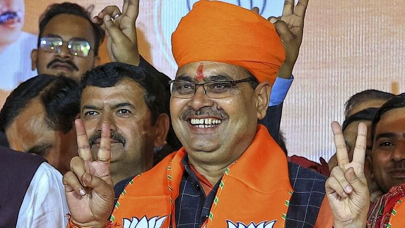 <div class="paragraphs"><p>BJP MLA from Sanganer, Bhajanlal Sharma flashes the victory sign after he was appointed as the next Chief Minister of Rajasthan during the BJP Legislature Party meeting, in Jaipur.</p></div>