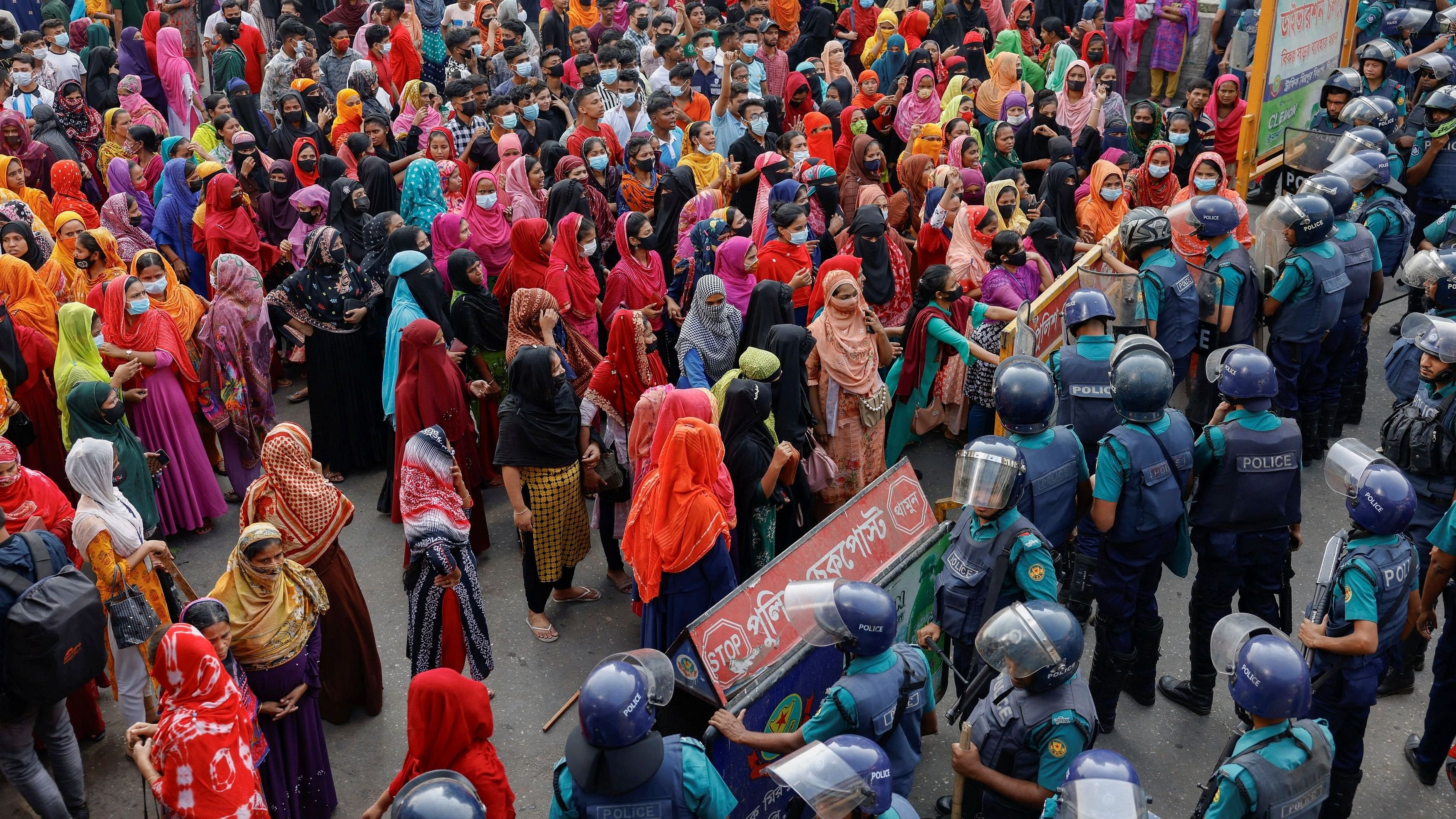 <div class="paragraphs"><p>File Photo: Garment industry workers push a barricade, as they protest on the street demanding a wage raise, at Mirpur area of Dhaka, Bangladesh, November 12, 2023. </p></div>