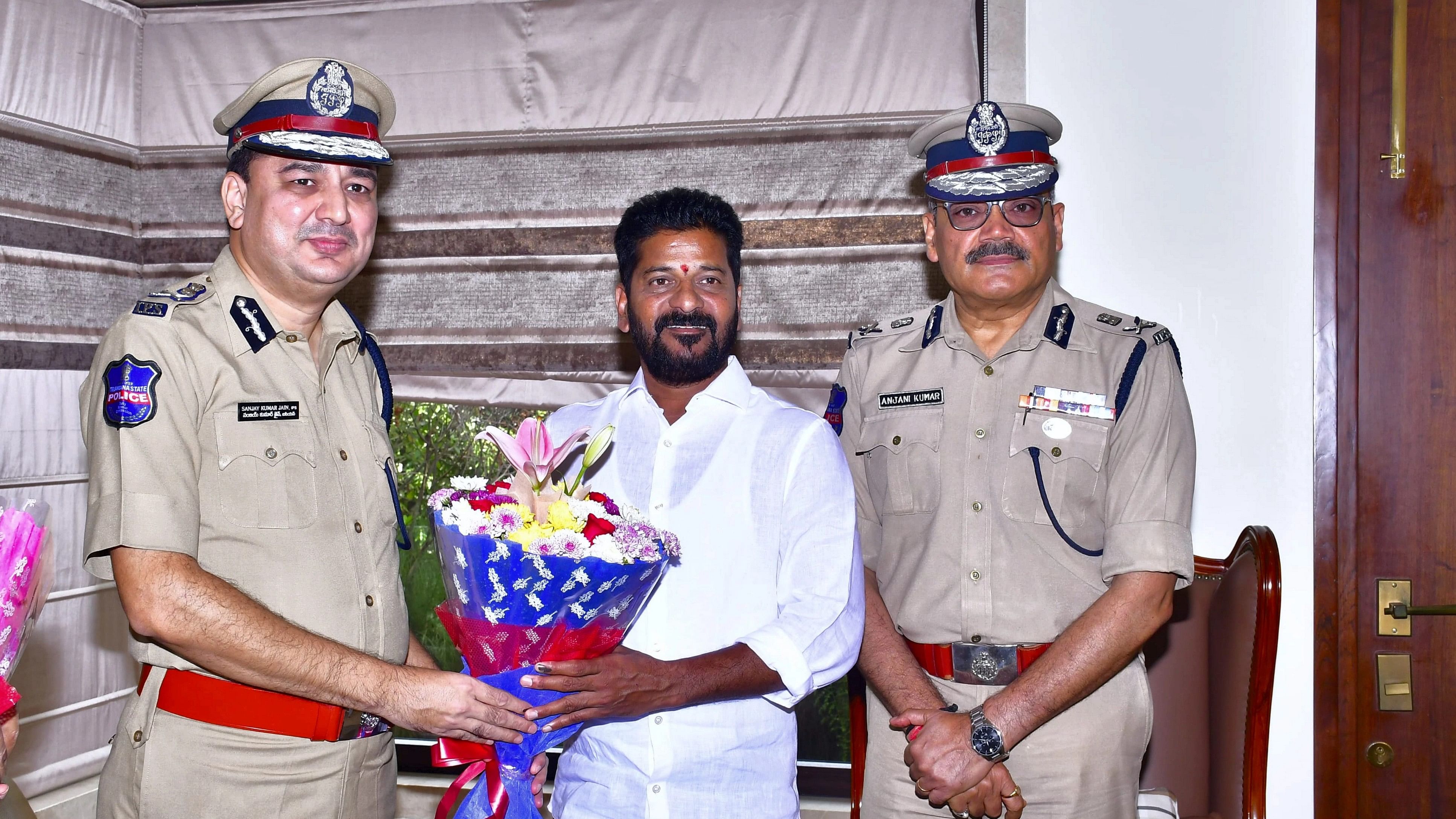 <div class="paragraphs"><p>Telangana Congress President A Revanth Reddy with Telangana DGP Anjani Kumar and Additional DG Sanjay Kumar Jain during a meeting, in Hyderabad, Sunday, Dec. 3, 2023. </p></div>