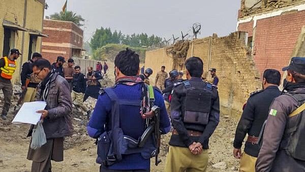 <div class="paragraphs"><p>Security personnel at the site after militants rammed an explosive-laden truck into a security forces' post, in Dera Ismail Khan district, Khyber-Paktunkhwa, Pakistan.</p></div>