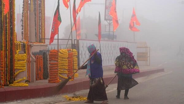 <div class="paragraphs"><p>Sweepers clean a road amid dense morning fog before PM's arrival in Ayodhya on December 30.</p></div>