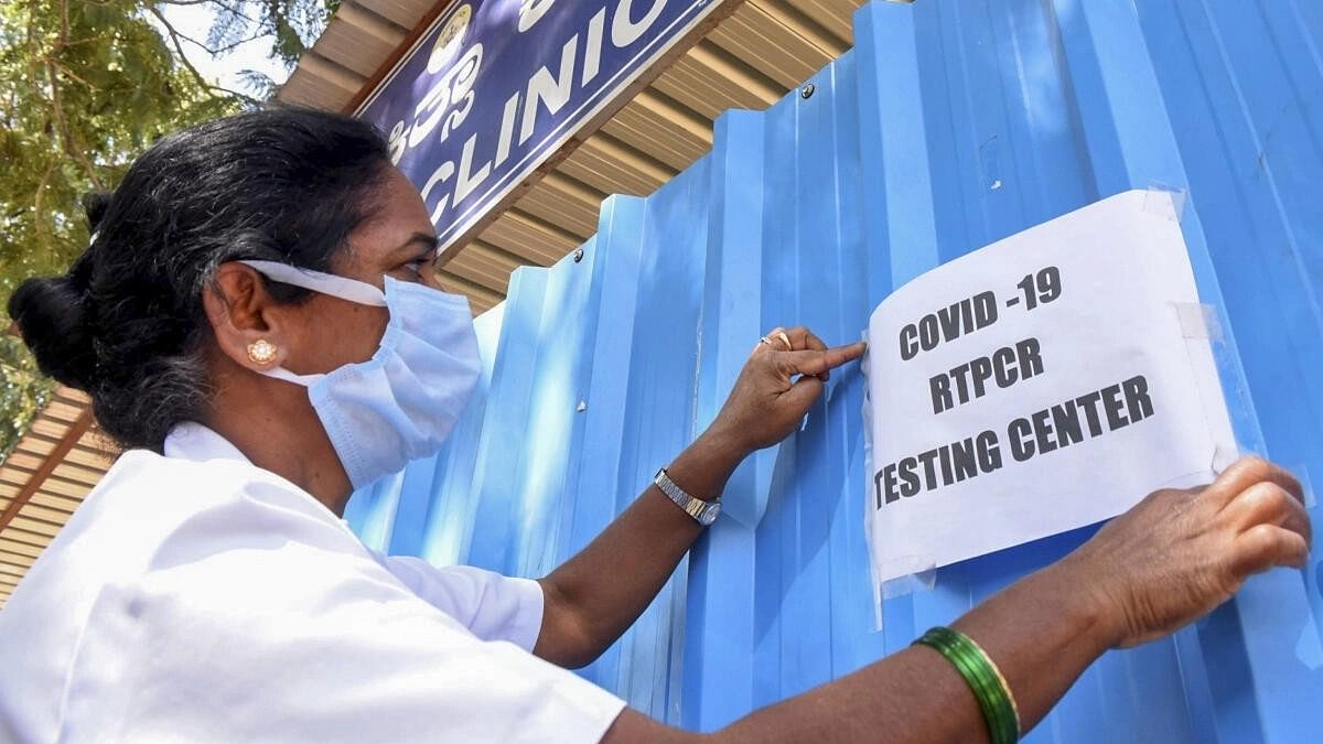 <div class="paragraphs"><p>A medic puts up a notice at a Covid-19 testing centre of the district hospital after cases of Covid-19 sub-variant JN.1 were detected in India, in Chikkamagaluru district, earlier this month&nbsp;</p></div>