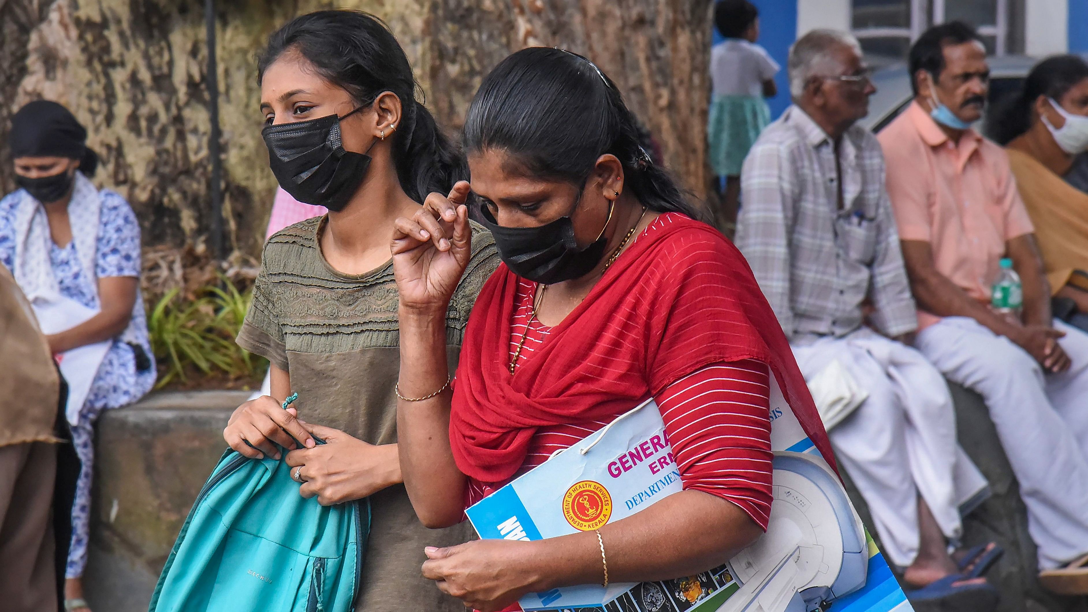 <div class="paragraphs"><p>Visitors wear masks at the Ernakulam Government Hospital after rise in number of Covid cases, in Kochi, Monday, Dec. 18, 2023.</p></div>