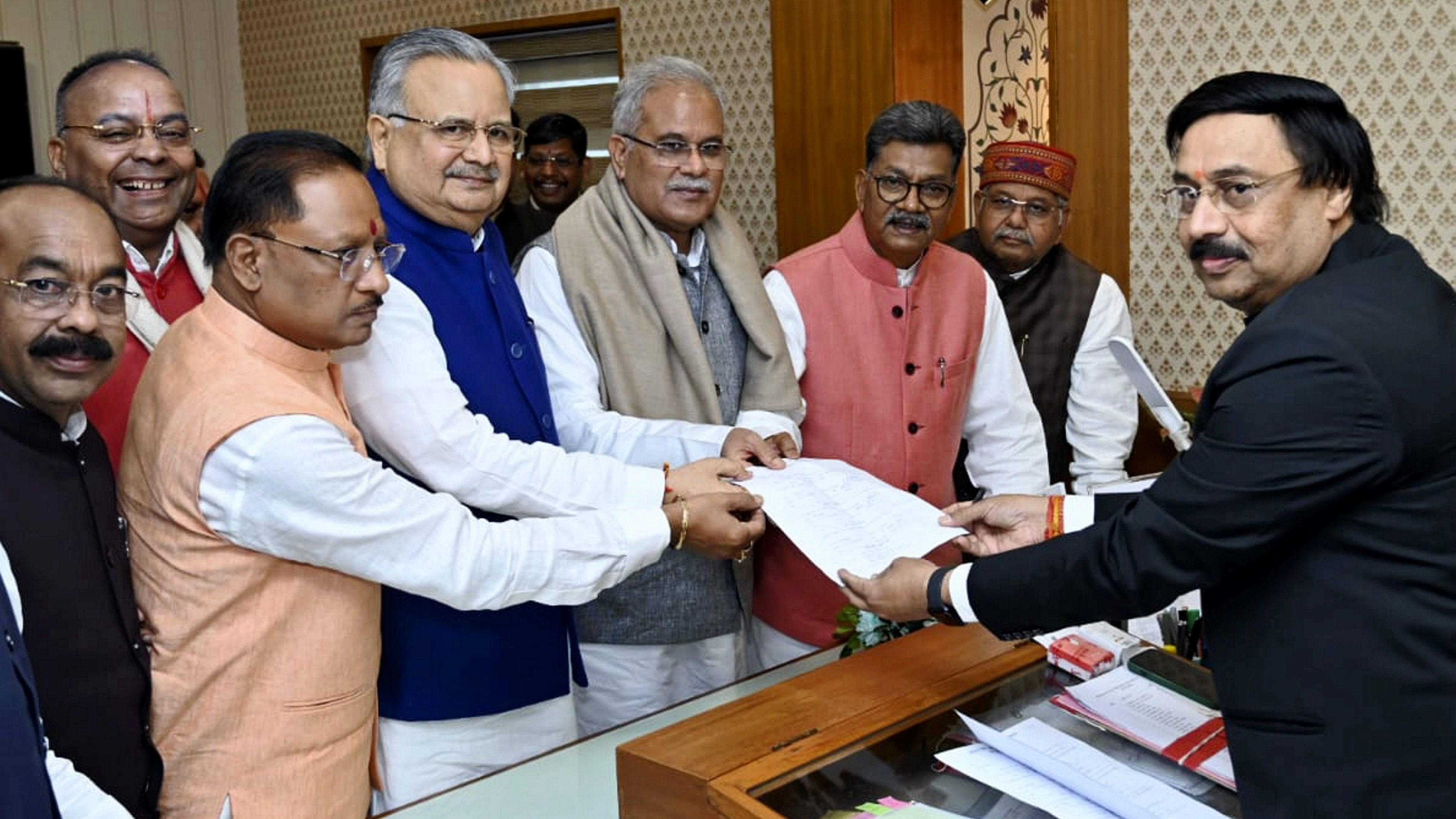 <div class="paragraphs"><p> BJP leader Raman Singh with Chhattisgarh Chief Minister Vishnu Deo Sai and former CM Bhupesh Baghel submits his nomination papers for the post of State Assembly Speaker to Secretary Dinesh Sharma, in Raipur, Sunday, Dec. 17, 2023. </p></div>