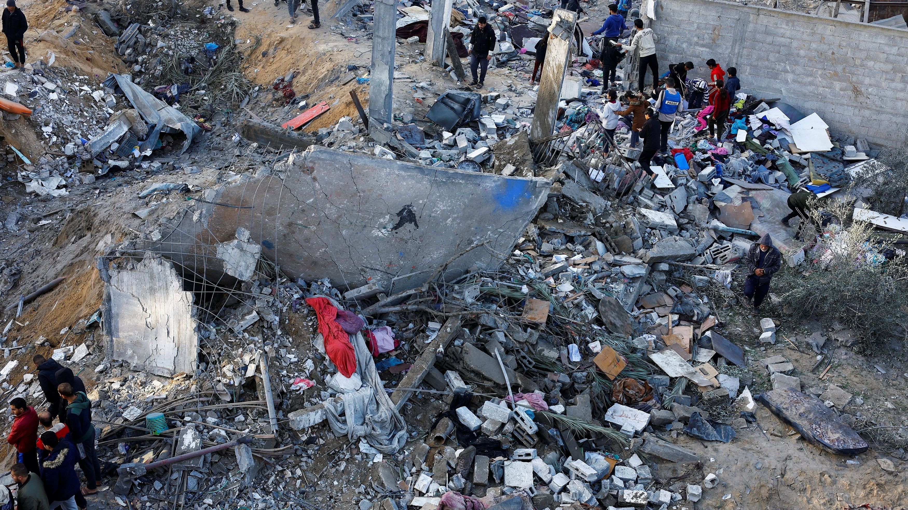 <div class="paragraphs"><p>Palestinians search for casualties at the site of Israeli strikes on houses amid the ongoing conflict between Israel and the Palestinian Islamist group Hamas, in Rafah in the southern Gaza Strip December 12, 2023. </p></div>