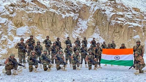 <div class="paragraphs"><p>Ladakh: Indian Army soldiers pose for a photograph with the national flag on the occasion of New Year 2022, at the Galwan Valley in Ladakh.</p></div>