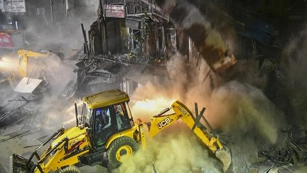 <div class="paragraphs"><p>A crane being used to demolish the dilapidated structure of Bhide Wada, where social reformer Mahatma Jyotiba Phule and his wife Savitribai Phule started the first school for girls in 1848, a month after court orders, in Pune, Monday night, Dec 4, 2023</p></div>