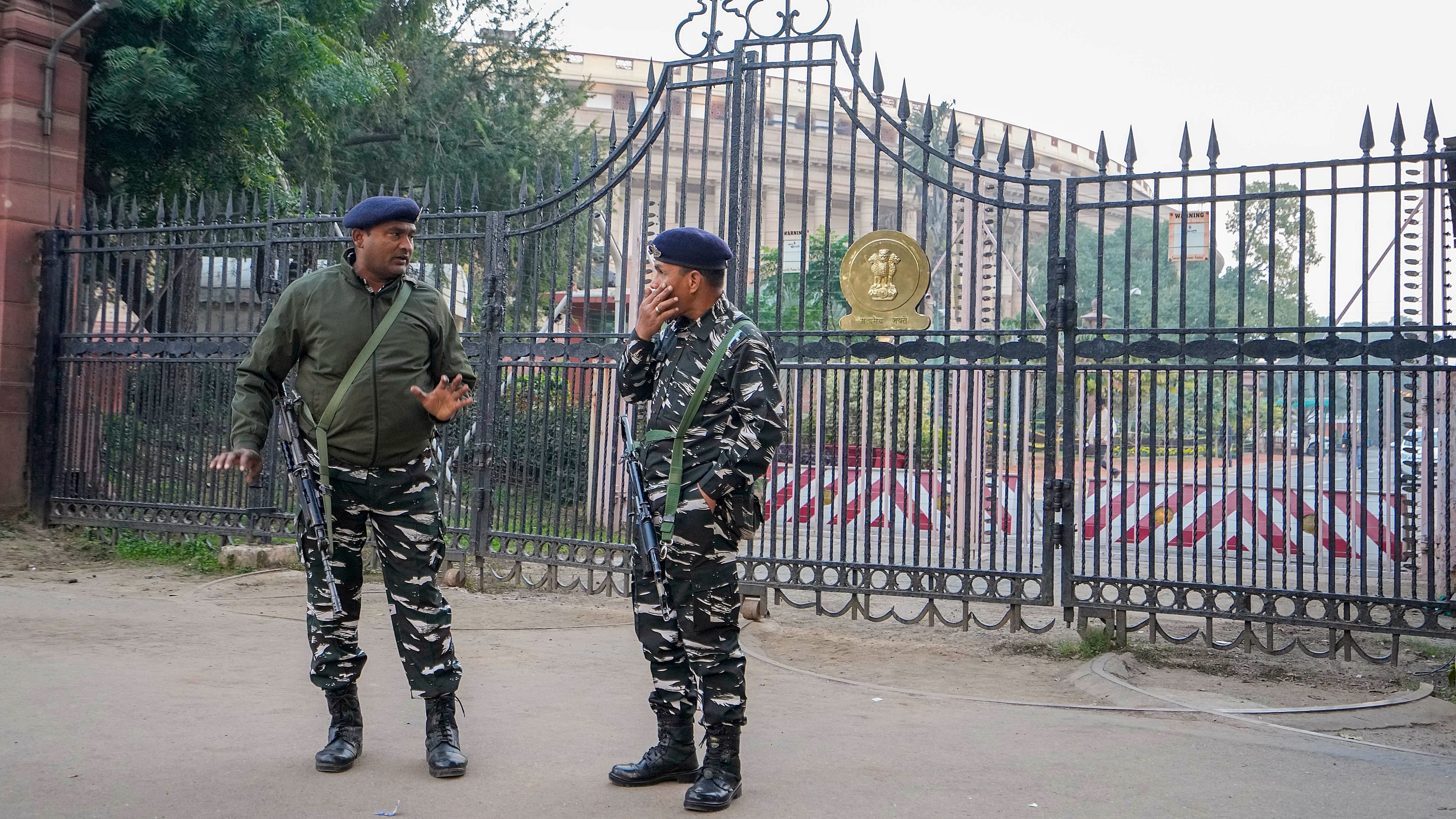 <div class="paragraphs"><p>Security personnel stand guard outside the Parliament House complex during the Winter session, in New Delhi.&nbsp;</p></div>