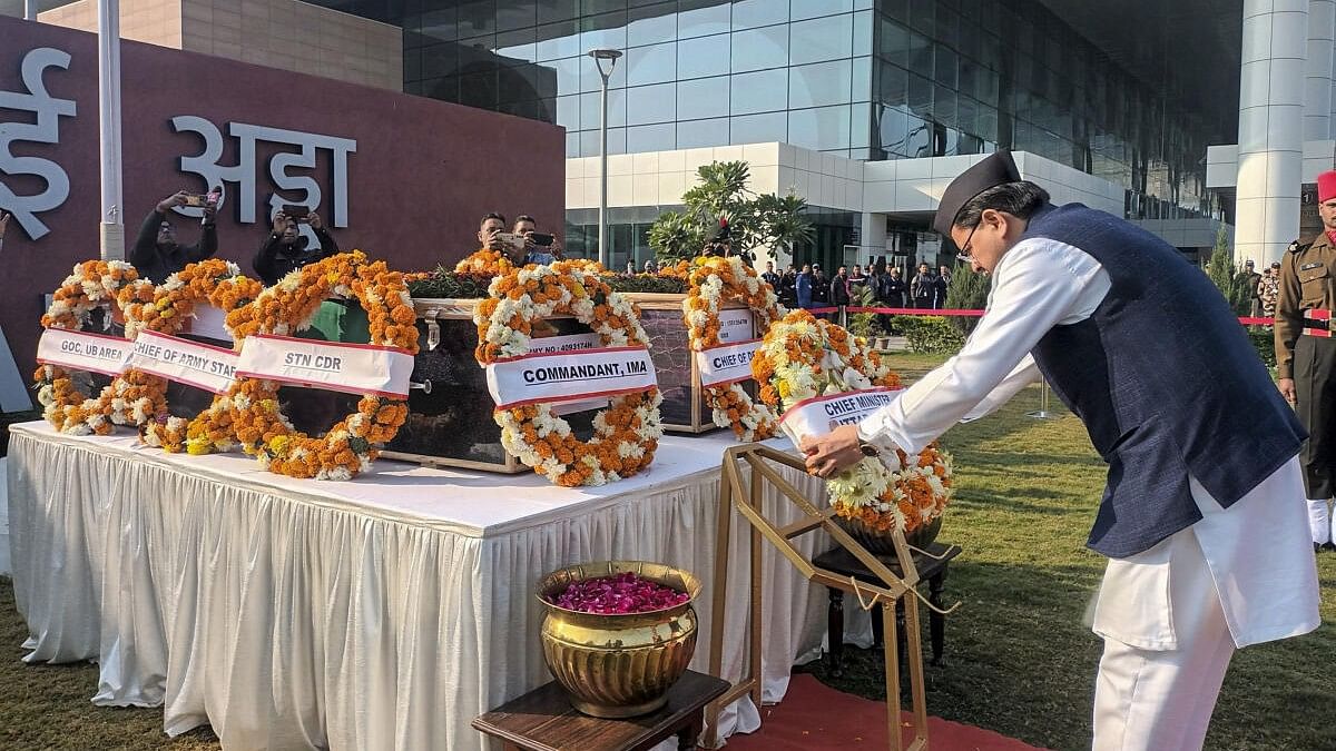 <div class="paragraphs"><p>Uttarakhand Chief Minister Pushkar Singh Dhami pays his last respects to two Army personnel killed in a recent militant attack in Poonch during a wreath-laying ceremony, in Dehradun, Monday, Dec. 25, 2023.</p></div>