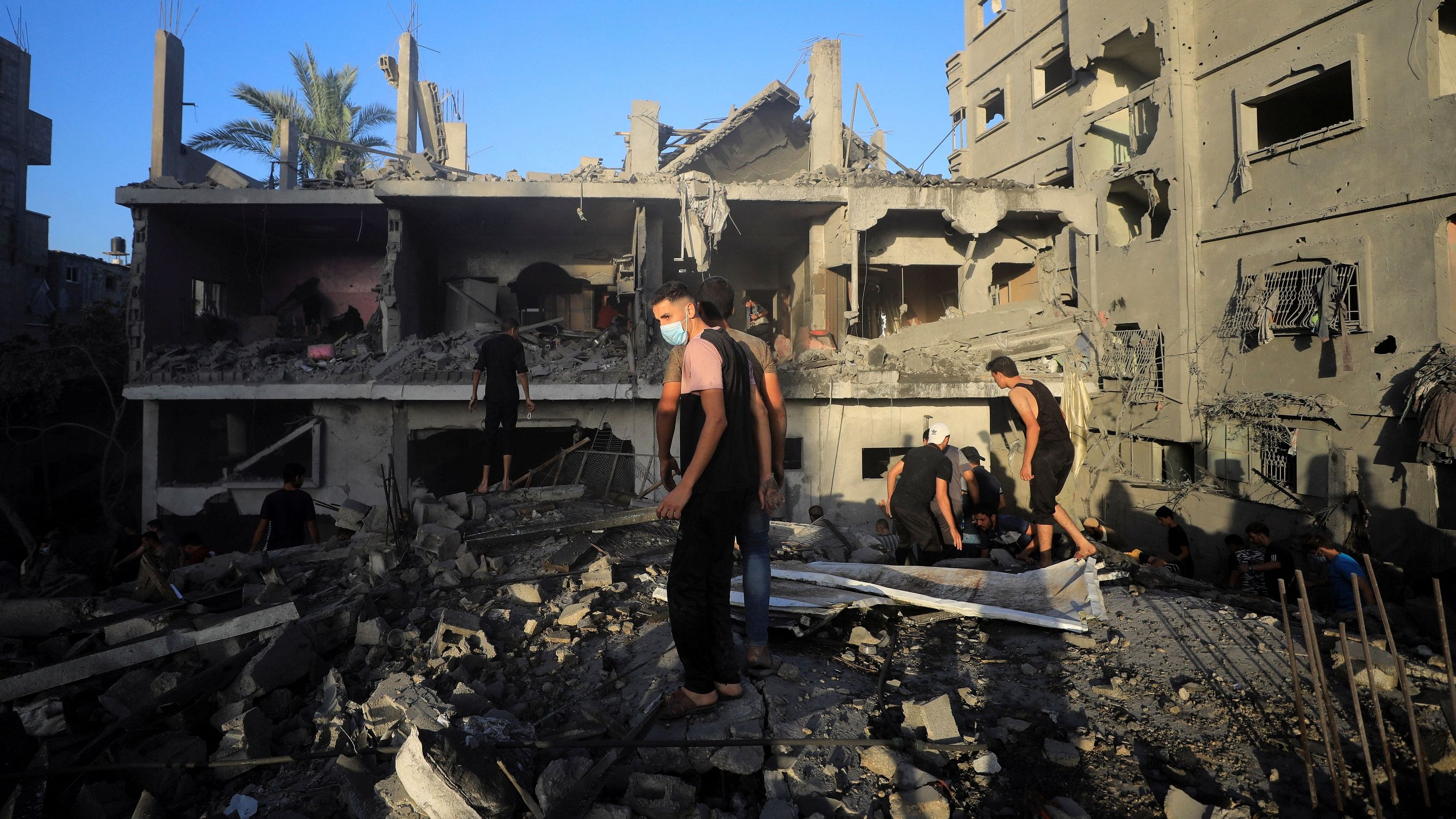 <div class="paragraphs"><p>Palestinians evacuate the site of Israeli strikes on houses in Maghazi refugee camp.&nbsp;</p></div><div class="paragraphs"><p><strong><br></strong></p></div>