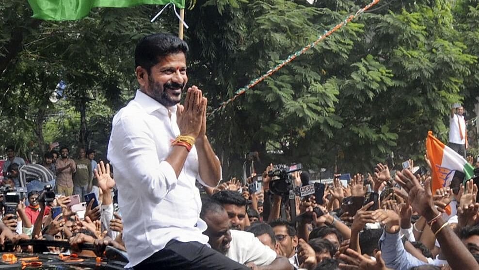 <div class="paragraphs"><p>Congress Telangana President A Revanth Reddy greets party workers and supporters celebrating the party's lead during counting of votes for Telangana Assembly elections, in Hyderabad, Sunday, Dec. 3, 2023.</p></div>