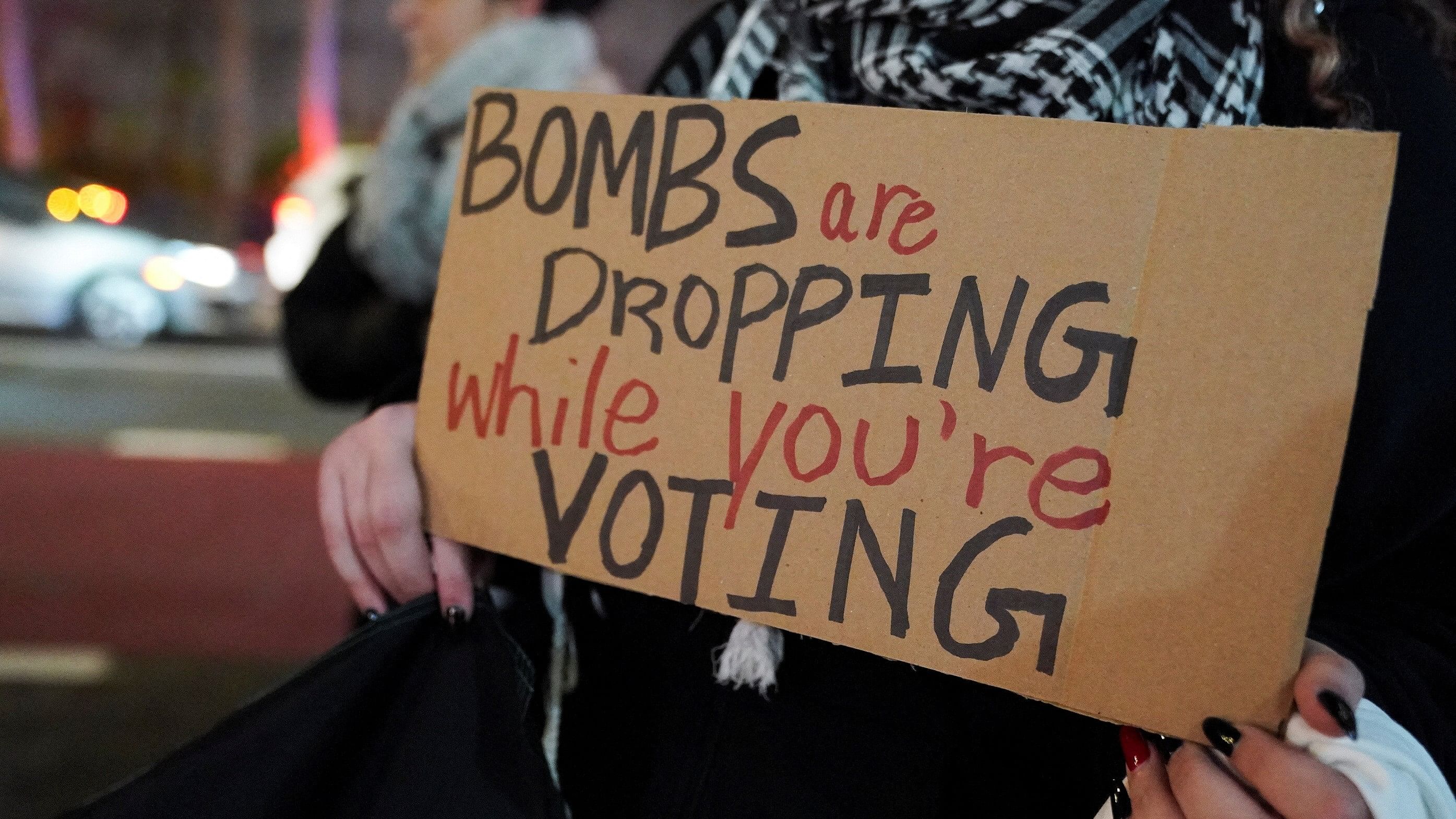 <div class="paragraphs"><p>A person holds a placard during a protest outside the UN headquarters as United Nations Security Council members attend a meeting to address the humanitarian crisis amid the war between Israel and the Palestinian Islamist group Hamas, in New York City, US, December 8, 2023. </p></div>