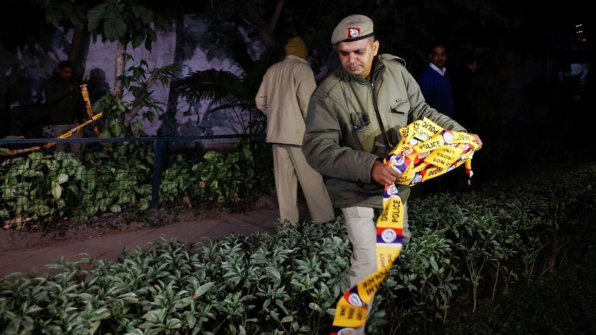 <div class="paragraphs"><p>A police officer removes the security tape outside the Israeli embassy, following an investigation on a reported explosion nearby, in New Delhi.</p></div>