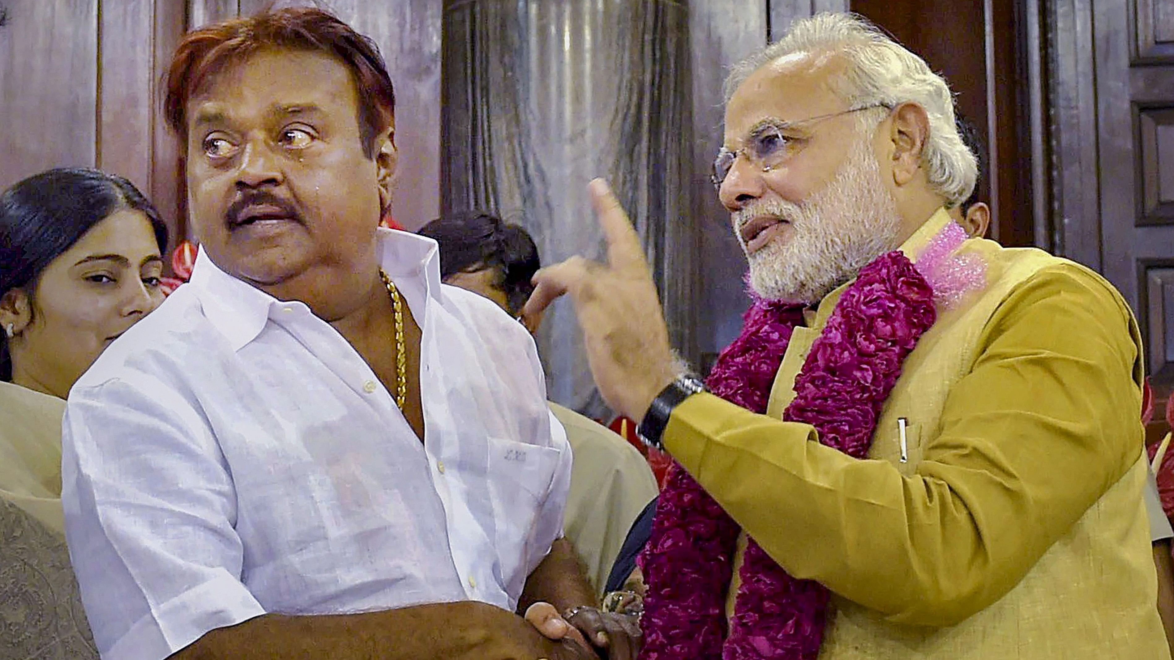 <div class="paragraphs"><p> Prime Minister Narendra Modi being greeted by DMDK chief Vijayakanth</p></div>
