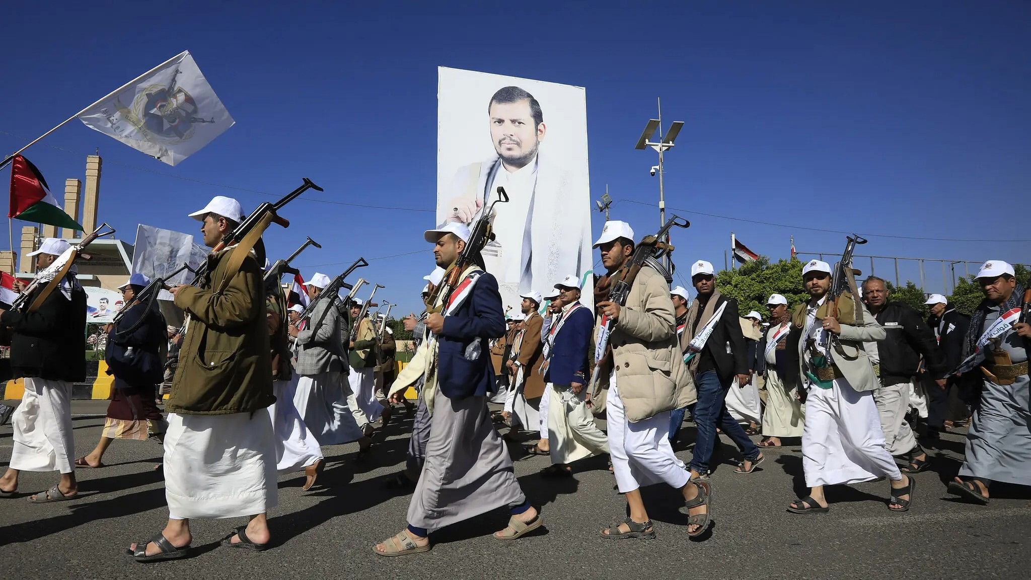 <div class="paragraphs"><p>Newly recruited Houthi fighters march past a large image of their leader, Abdul-Malik al-Houthi, in December.<br></p></div>