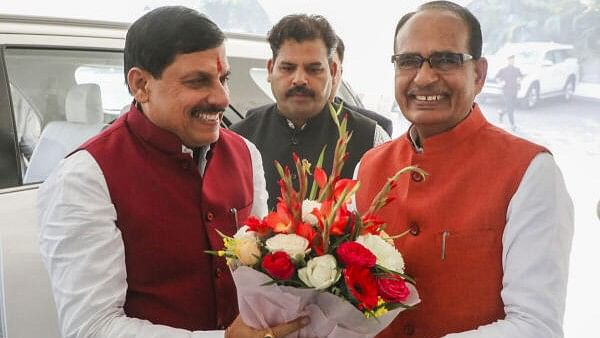 <div class="paragraphs"><p>Madhya Pradesh Chief Minister Mohan Yadav being greeted with a flower bouquet by former chief minister Shivraj Singh Chouhan, Bhopal, Tuesday, Dec. 26, 2023.</p></div>