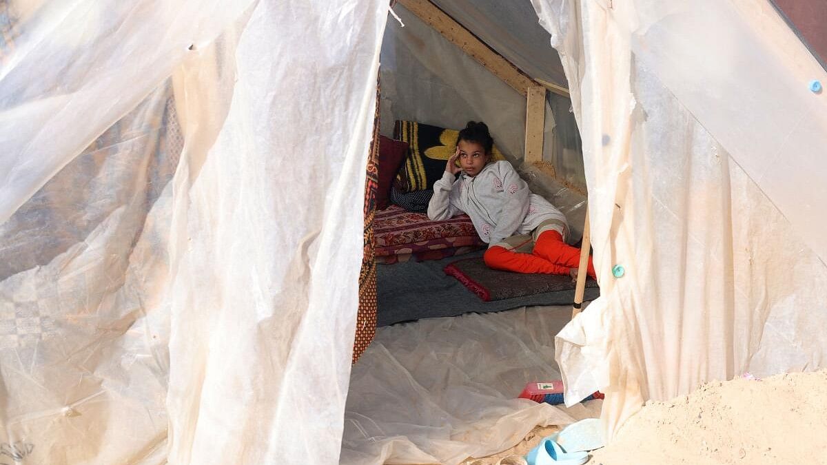 <div class="paragraphs"><p>A displaced Palestinian girl, who fled her house due to Israeli strikes, shelters in a tent camp, amid the ongoing conflict between Israel and the Palestinian Islamist group Hamas, in Rafah in the southern Gaza Strip, December 24, 2023.</p></div>