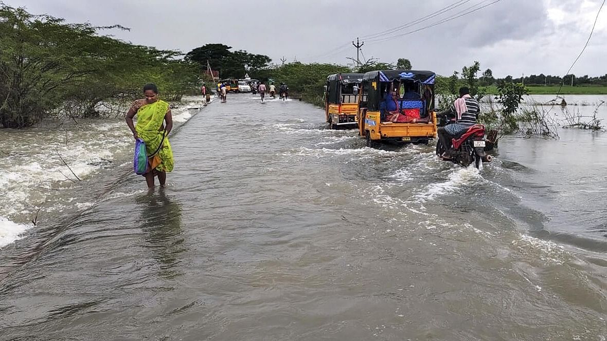 <div class="paragraphs"><p>A local wades through a waterlogged road after heavy rain owing to Cyclone Michaung, in Tirupati, Andhra Pradesh, Monday, Dec 4, 2023.</p></div>