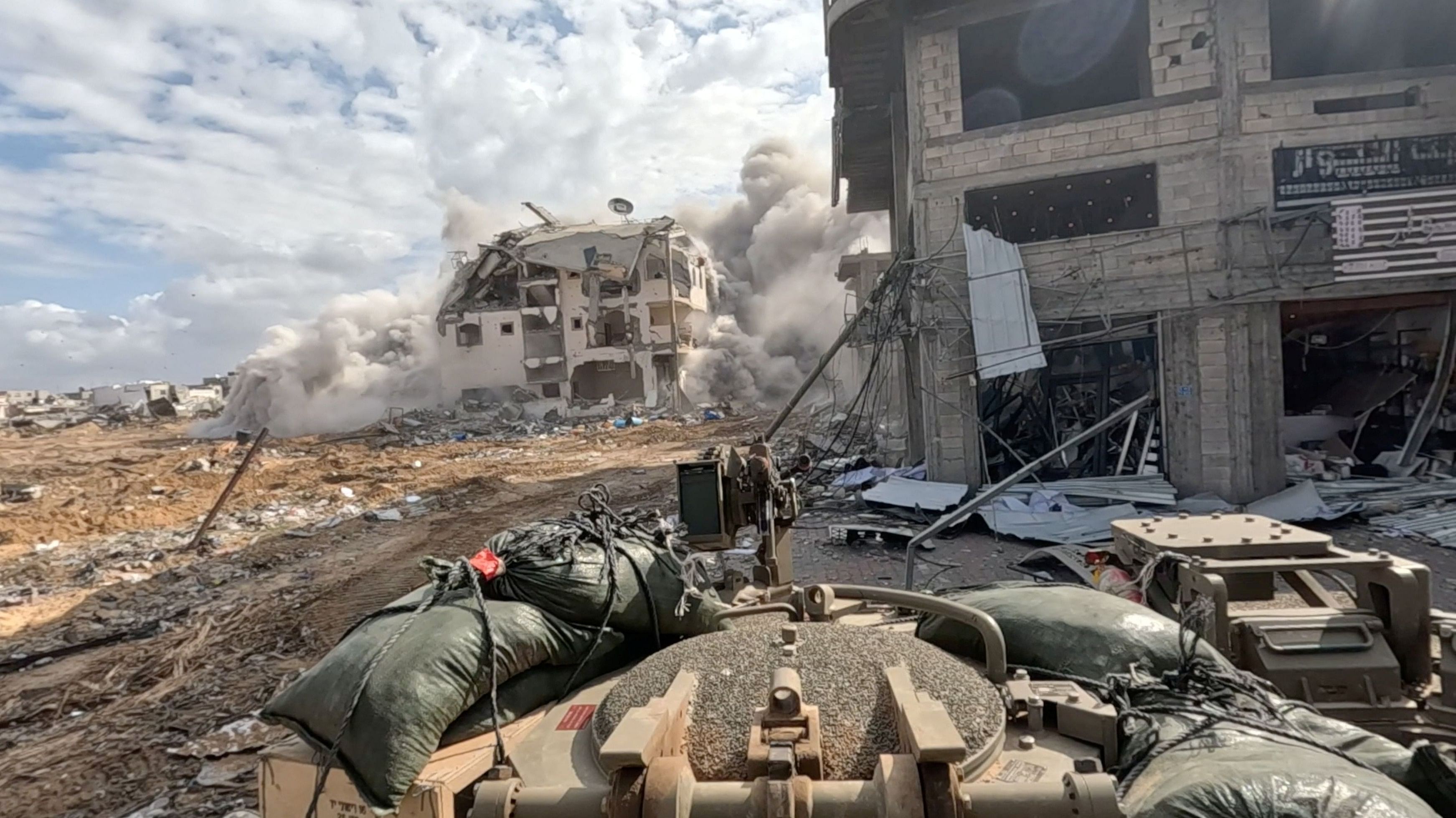 <div class="paragraphs"><p>Smoke rises from a building as Israeli soldiers operate in the Gaza Strip amid the ongoing conflict between Israel and the Palestinian Islamist group Hamas, in this screen grab taken from a handout video released on December 4, 2023.  </p></div>