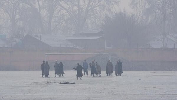 <div class="paragraphs"><p>Young men play cricket at a ground covered with frost during a cold winter morning as intense cold wave grips Kashmir valley, in Srinagar.</p></div>