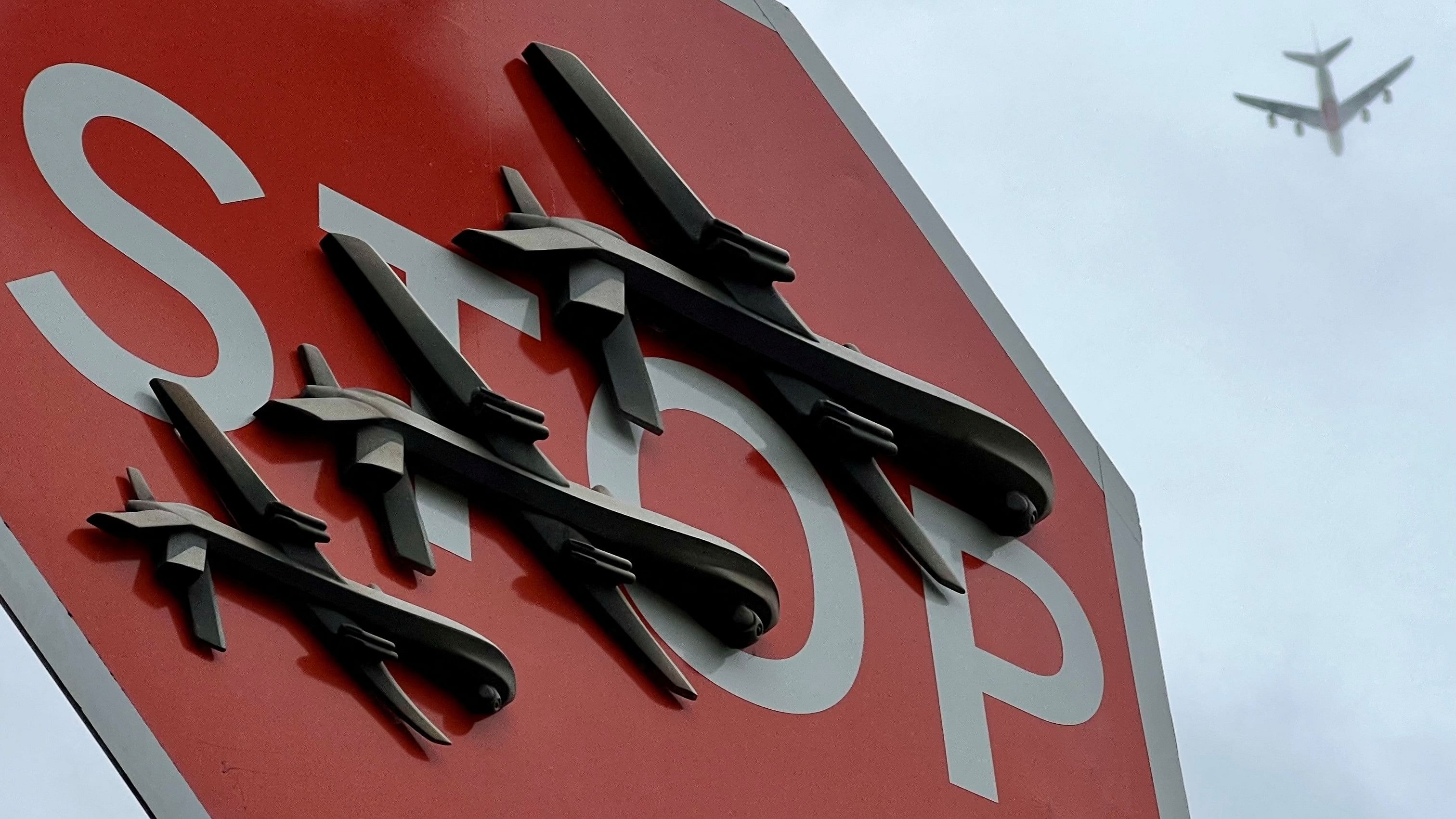 <div class="paragraphs"><p>Airplane passes overhead as Banksy artwork depicting drones covers a stop sign in London.</p></div>