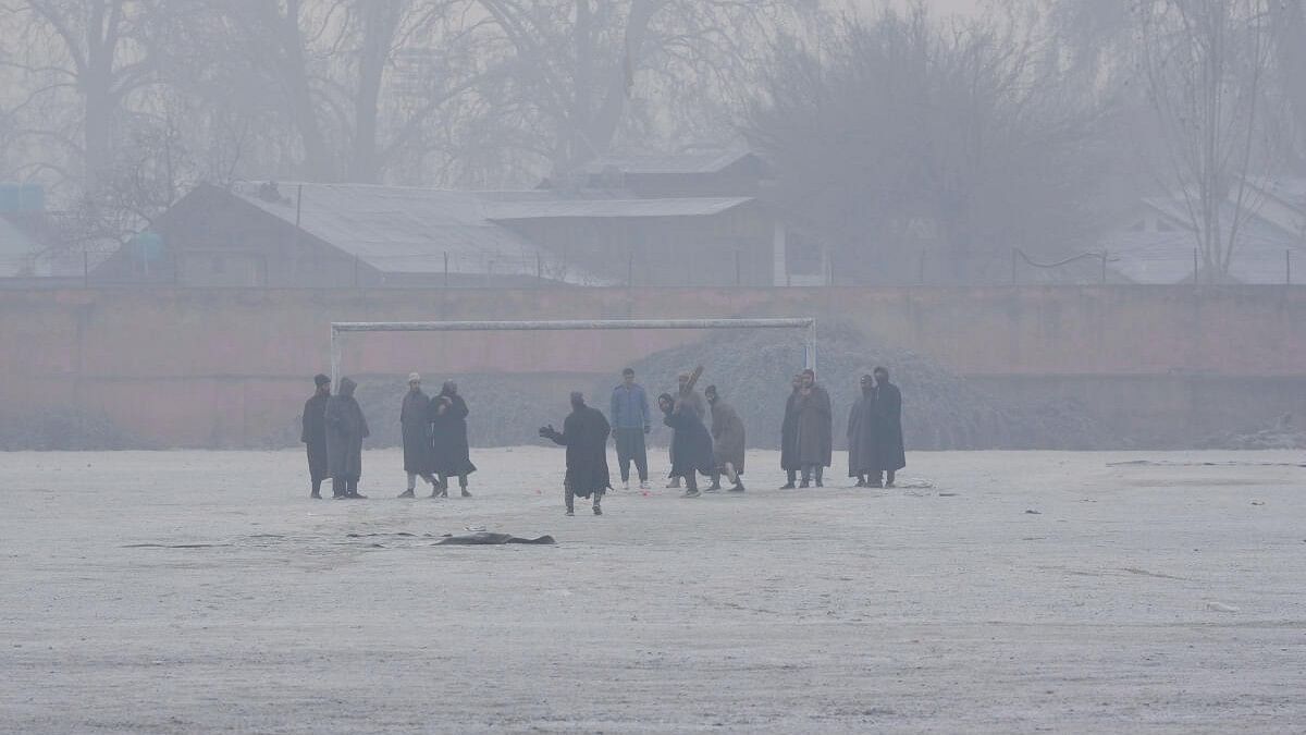 <div class="paragraphs"><p>Young men play cricket at a ground covered with frost during a cold winter morning as intense cold wave grips Kashmir valley, in Srinagar.</p></div>