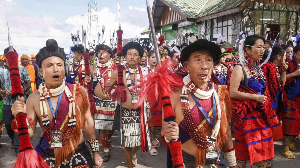 <div class="paragraphs"><p>Naga tribal people in their traditional attire take part in a procession during Hornbill festival 2022.</p></div>