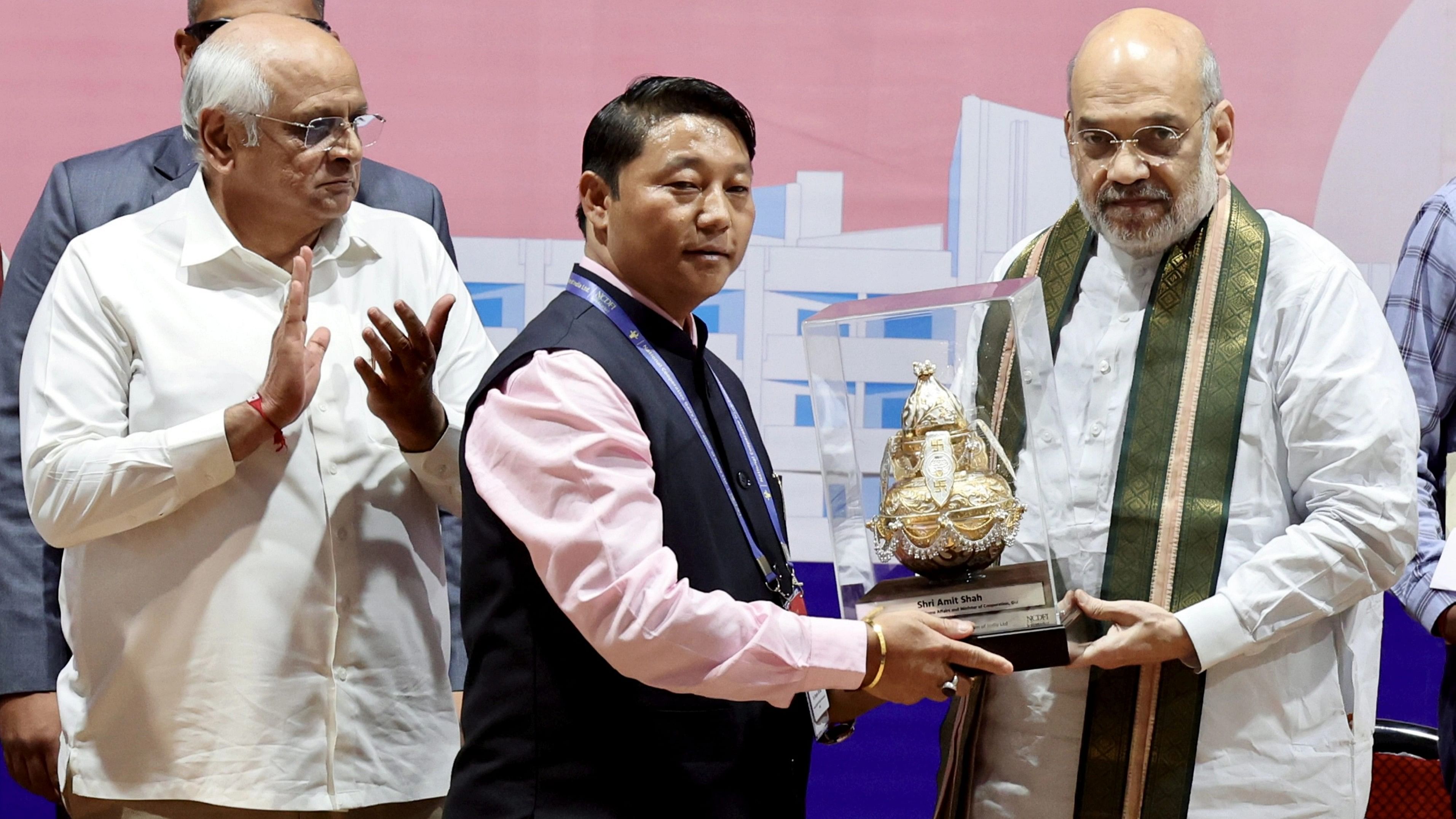 <div class="paragraphs"><p>Union Home Minister Amit Shah with Gujarat Chief Minister Bhupendra Patel during National Cooperative Dairy Federation of India Limited e-market awards, in Gandhinagar, on Saturday, Dec. 30, 2023. </p></div>